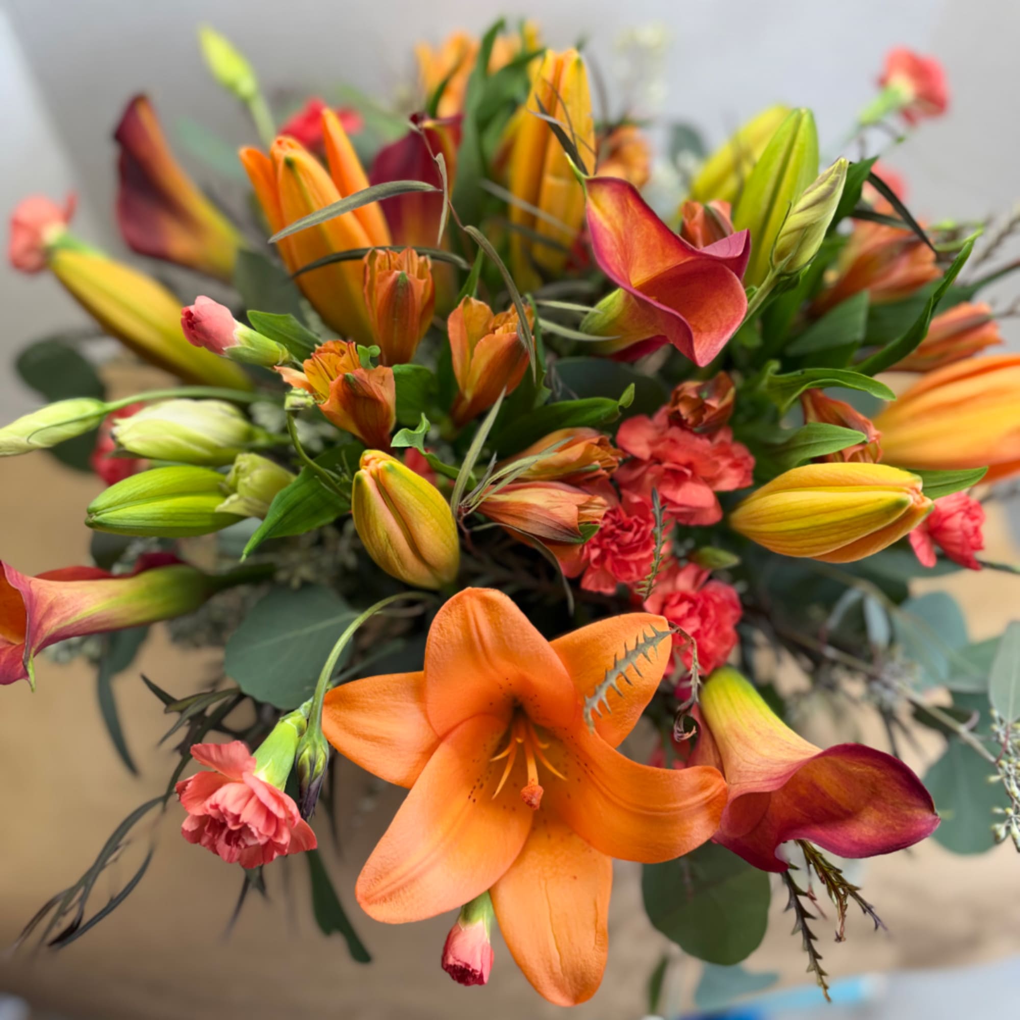 Bouquet of orange lilies, calla lilies, and pink carnations