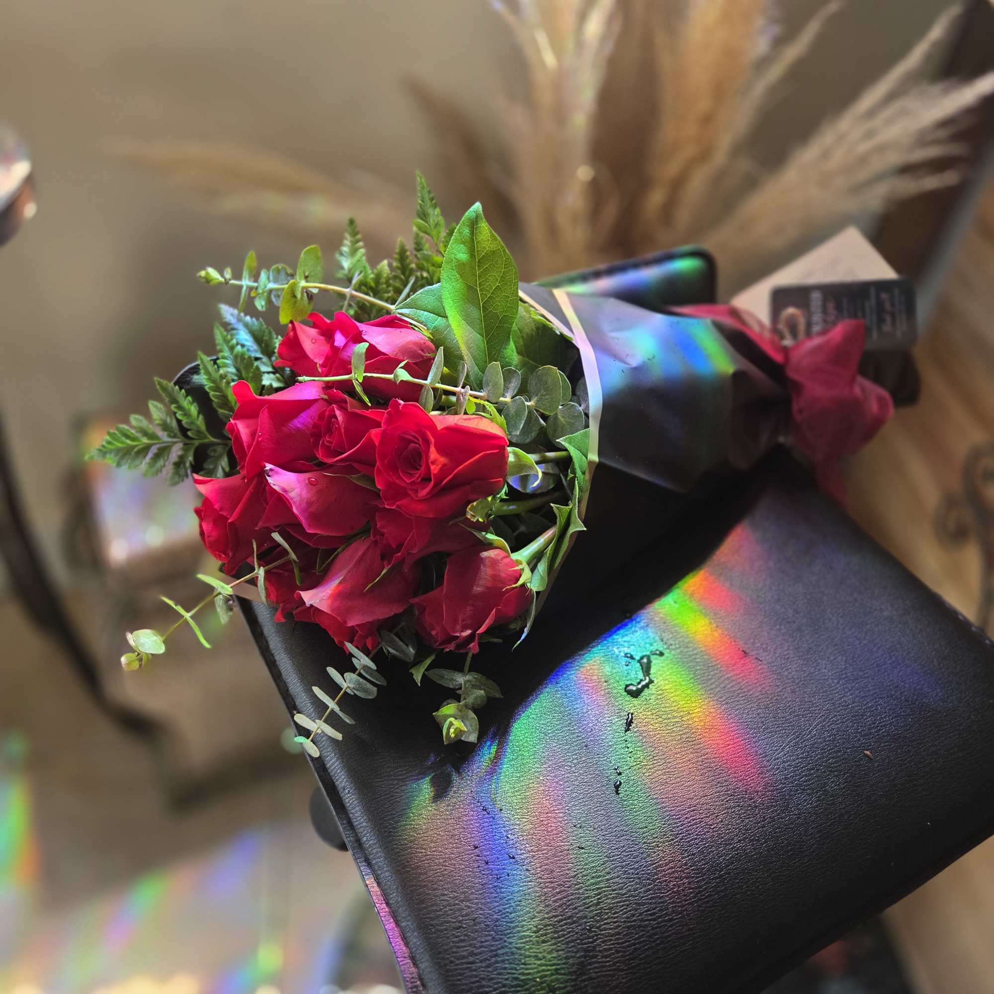 Bouquet of red roses wrapped in black paper