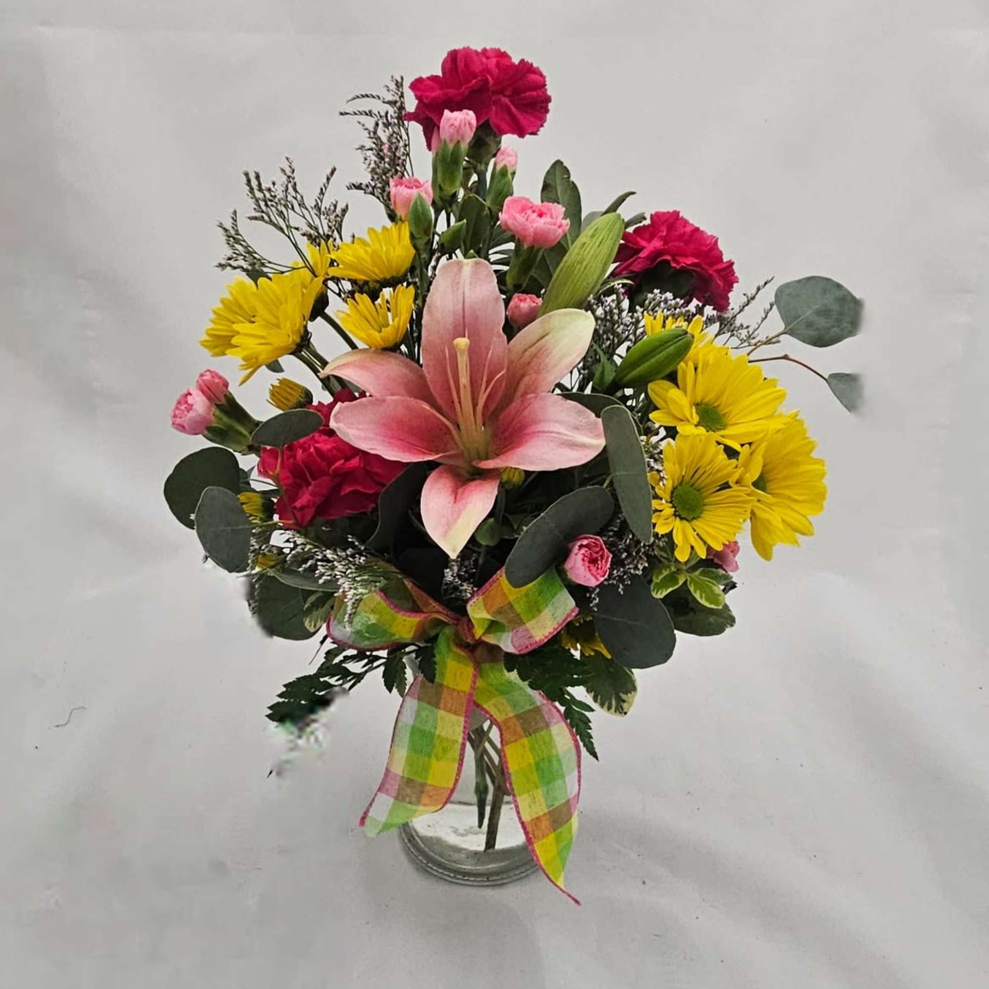 A showy pink lily takes center stage in this cheerful flower arrangement, photo 2 of 2