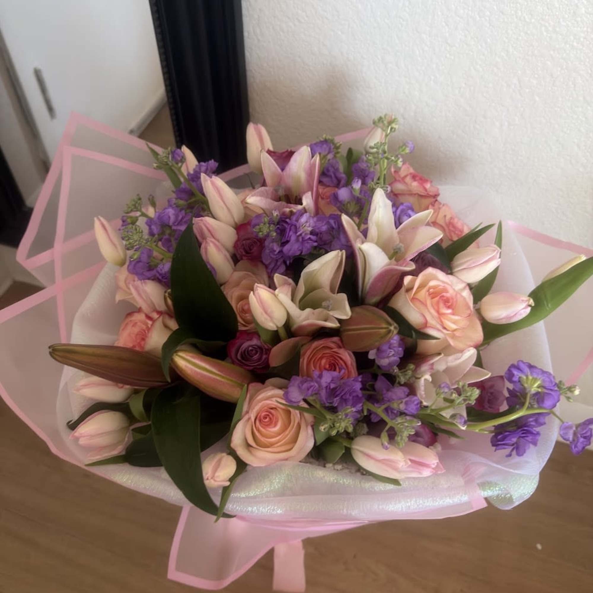 Beautiful floral arrangement featuring lilies, stock flowers, lilac roses, pink roses, and, photo 2 of 3