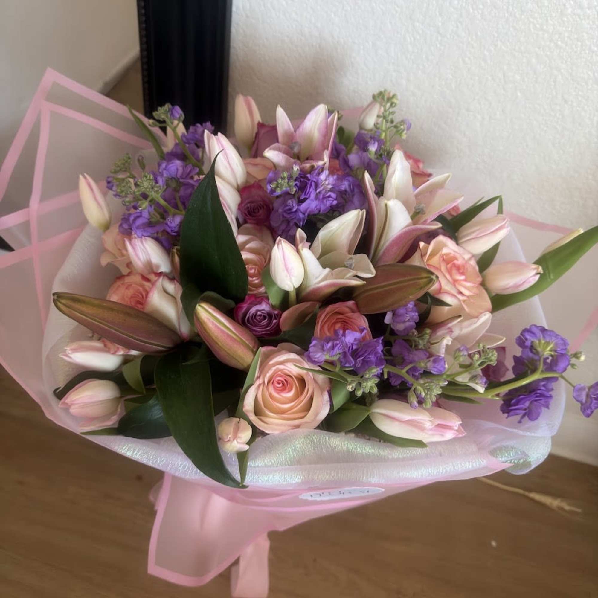 Beautiful floral arrangement featuring lilies, stock flowers, lilac roses, pink roses, and, photo 3 of 3