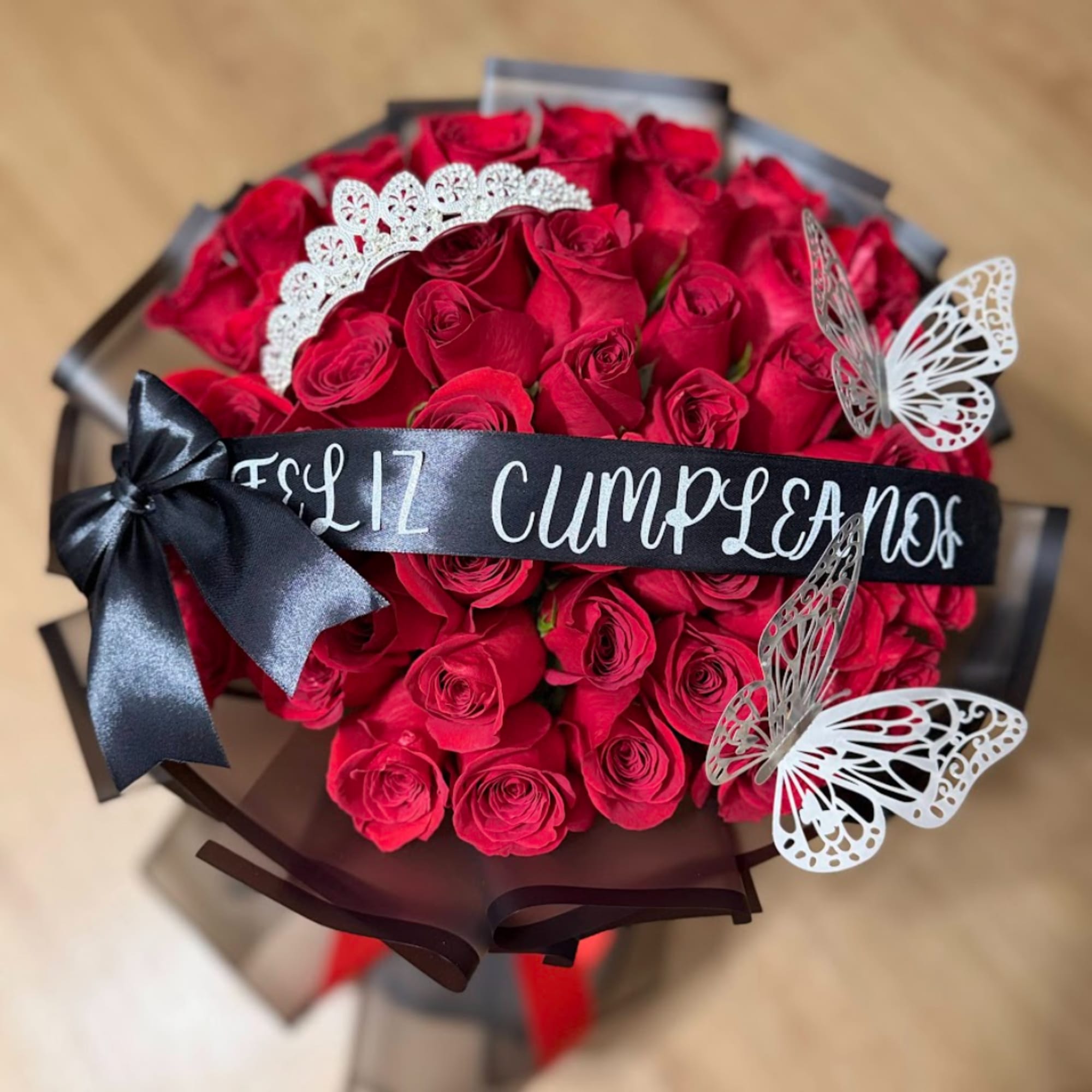 Bouquet of red roses with a black ribbon and butterfly decorations