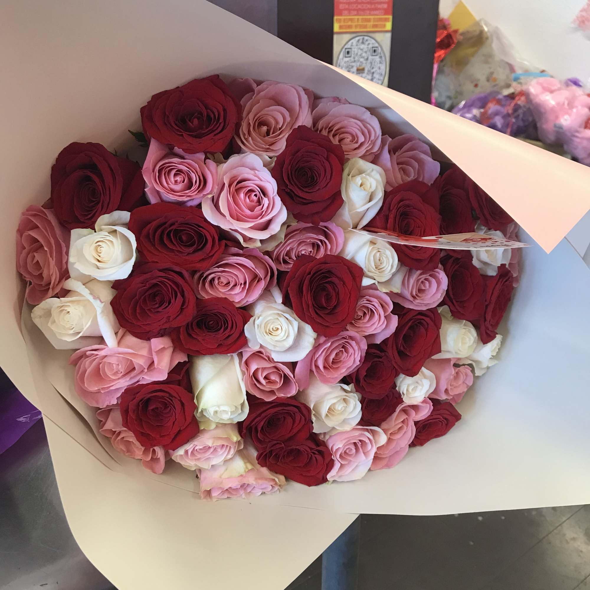 A lush, hand-tied floral bouquet built around classic roses and lilies-BUCHONES is