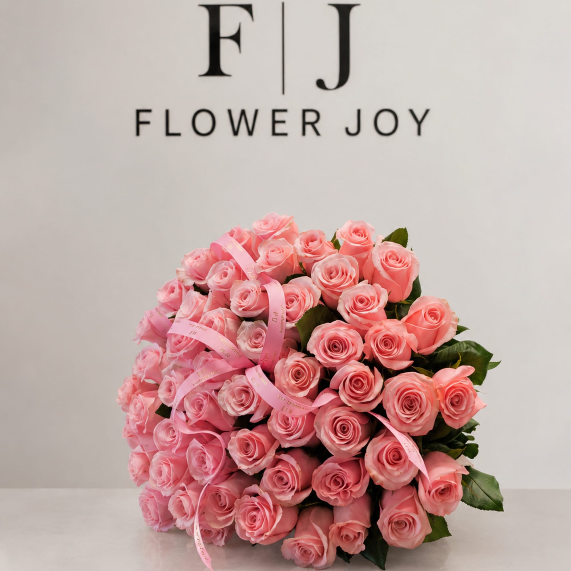 A luxurious arrangement of soft pink roses, beautifully gathered with delicate ribbon