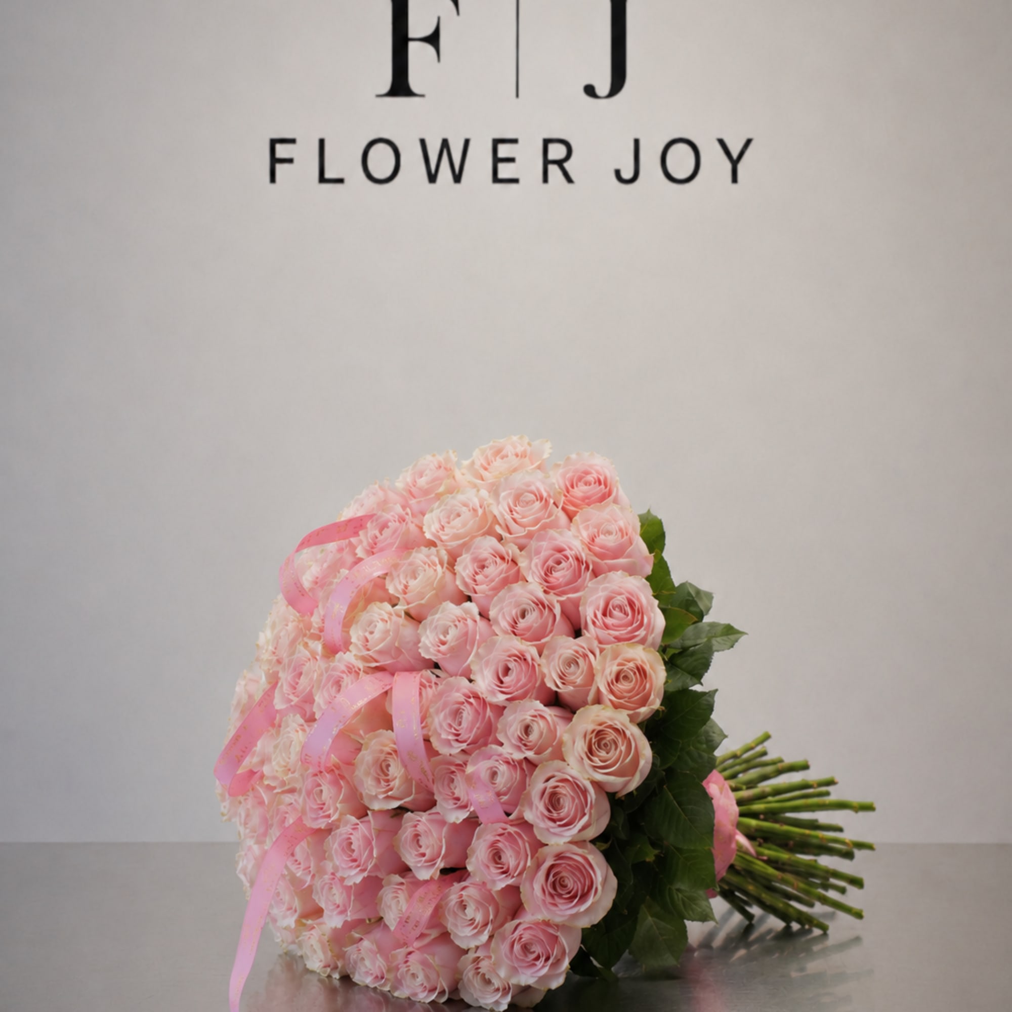 A charming bouquet of  soft pink roses, beautifully finished with delicate