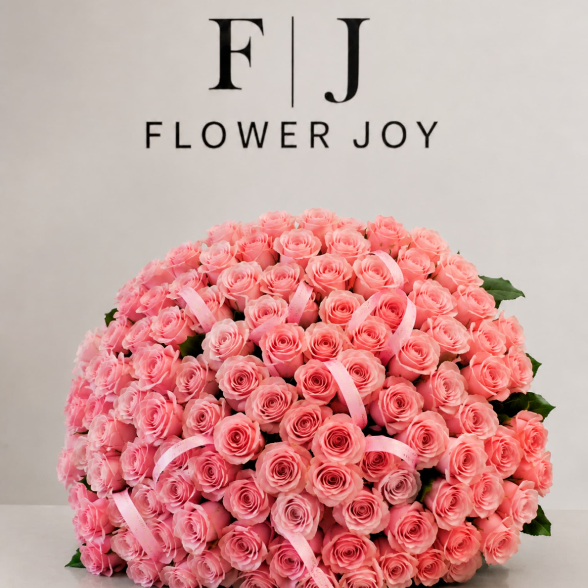 Large bouquet of pink roses with ribbon accents