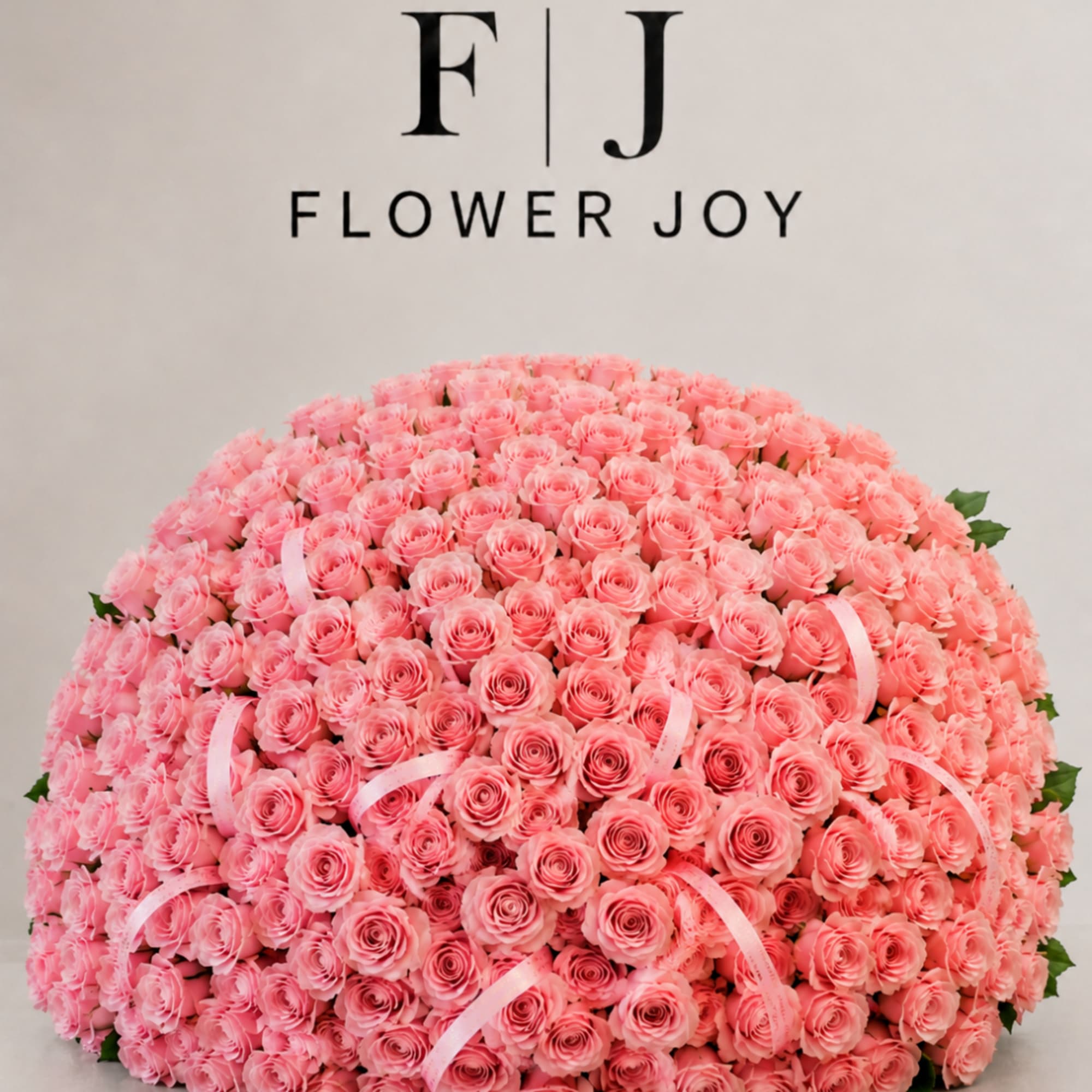 Large dome bouquet of pink roses with pale pink ribbon accents