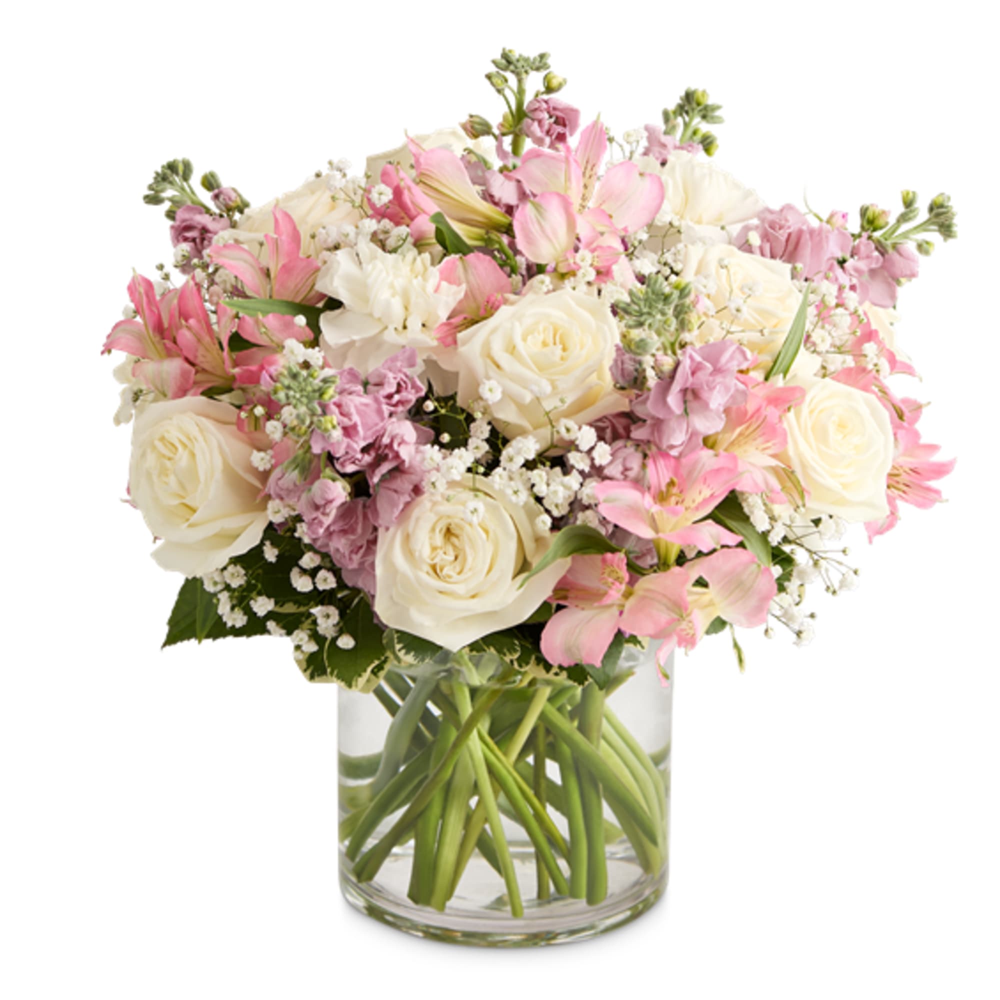 Pink and white bouquet of roses and mixed blooms in a clear glass vase