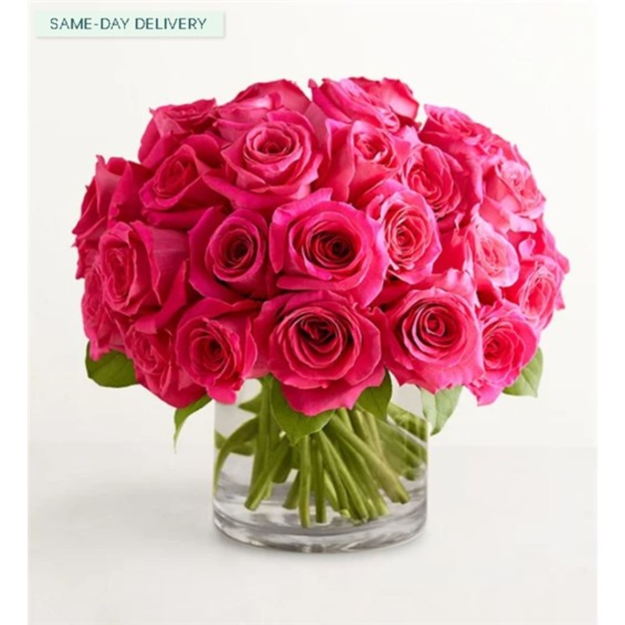 Bouquet of bright pink roses in a clear glass vase