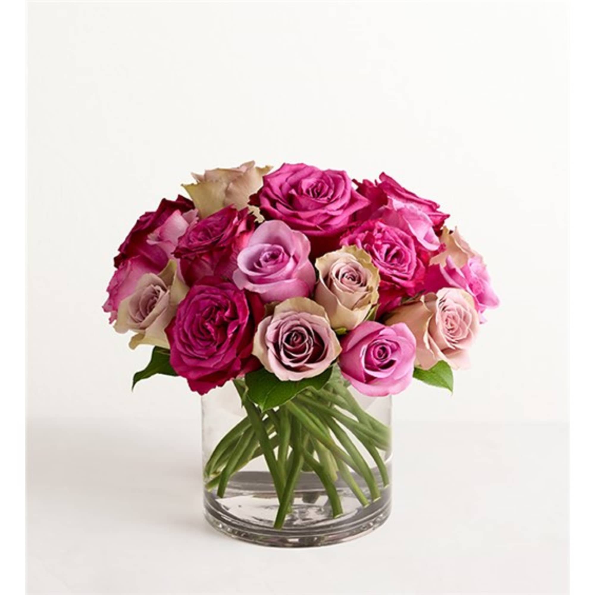 Bouquet of pink and magenta roses in a clear glass vase
