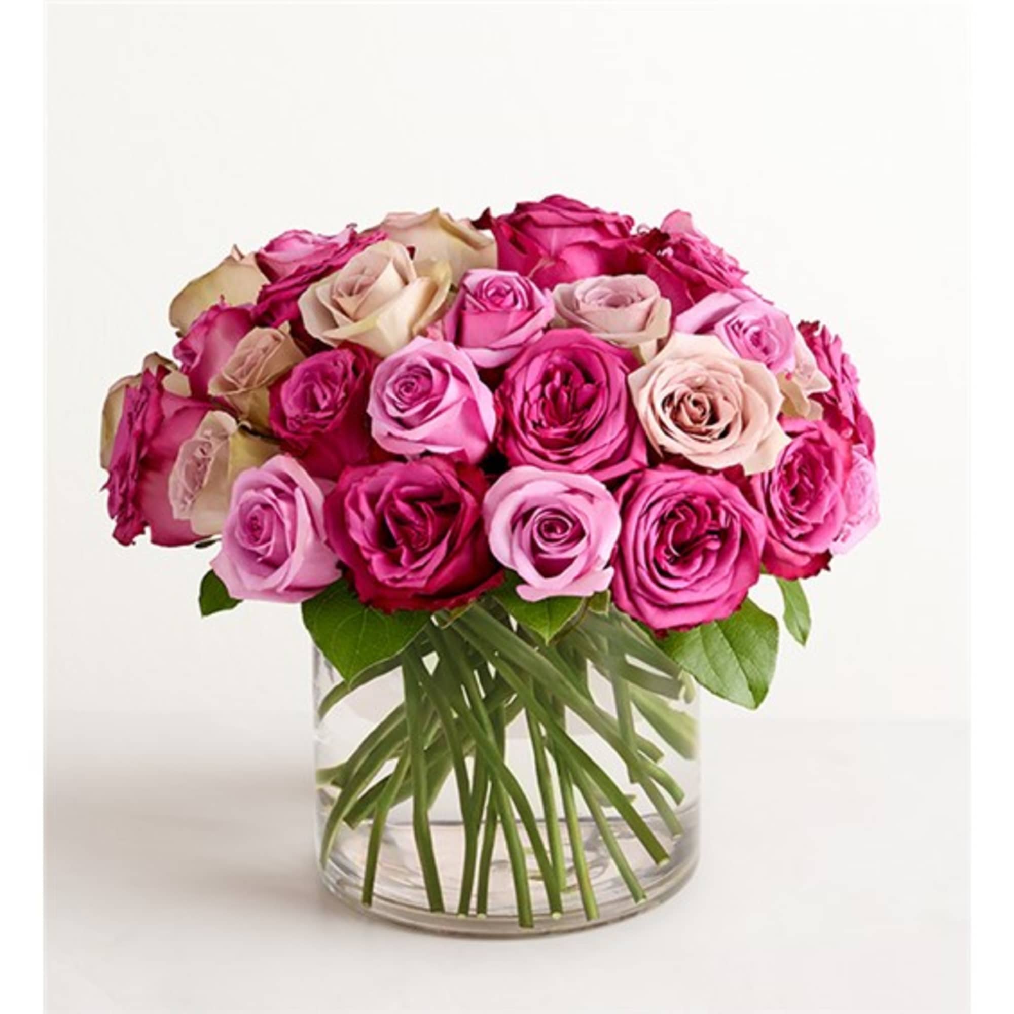 Bouquet of pink and blush roses in a clear glass vase