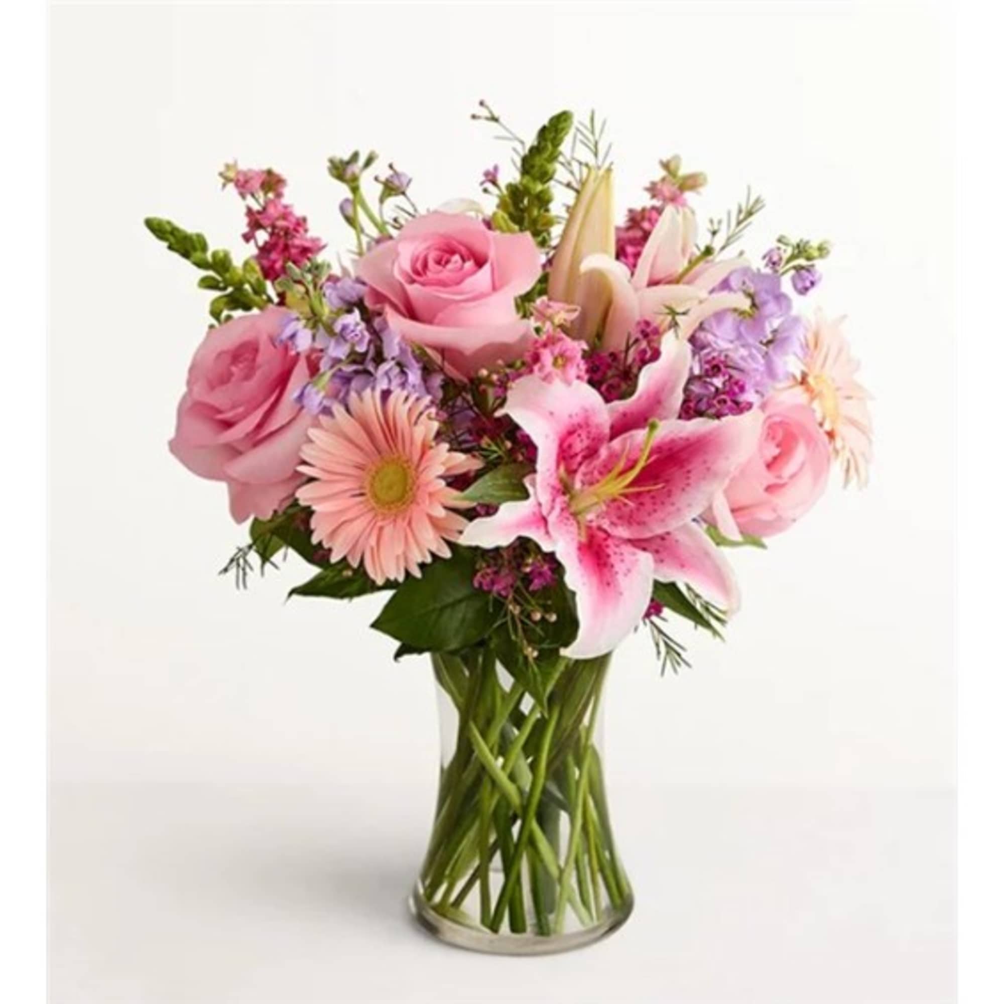 Pink roses and lilies in a clear glass vase