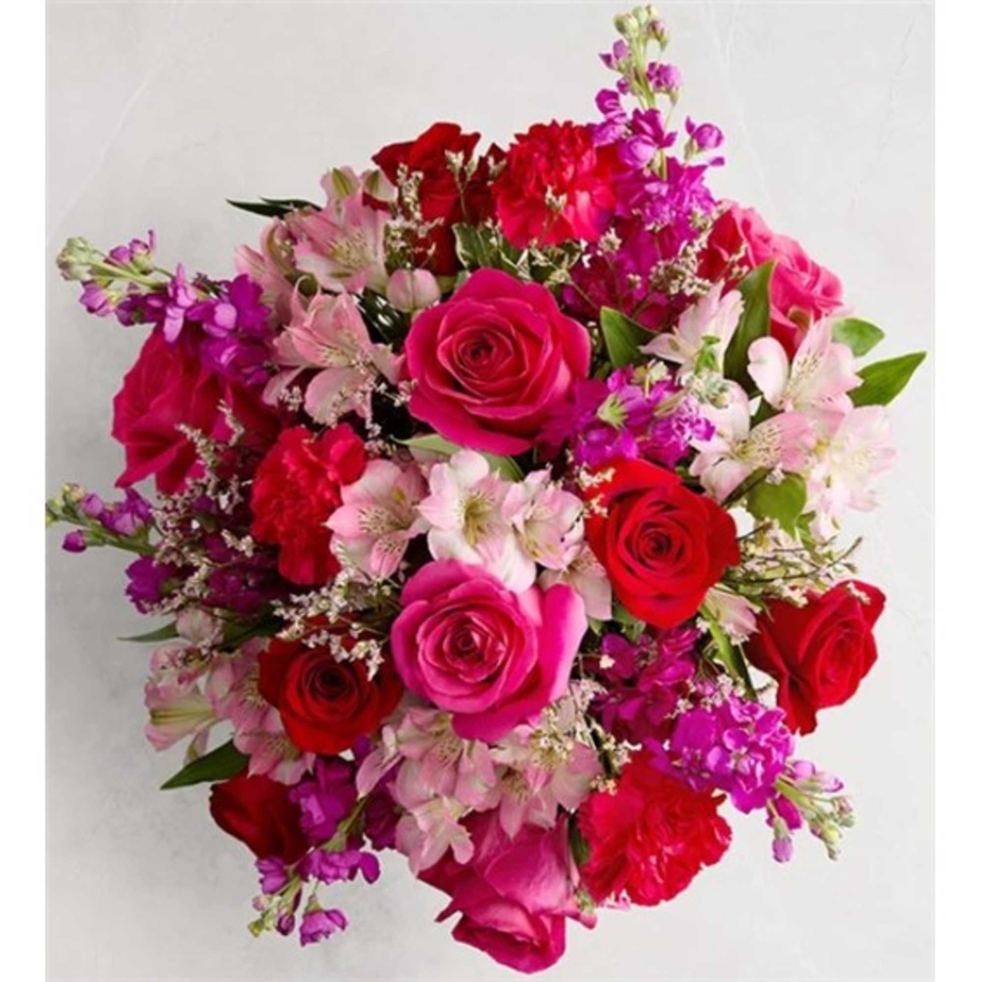 Round bouquet of red, pink, and purple flowers