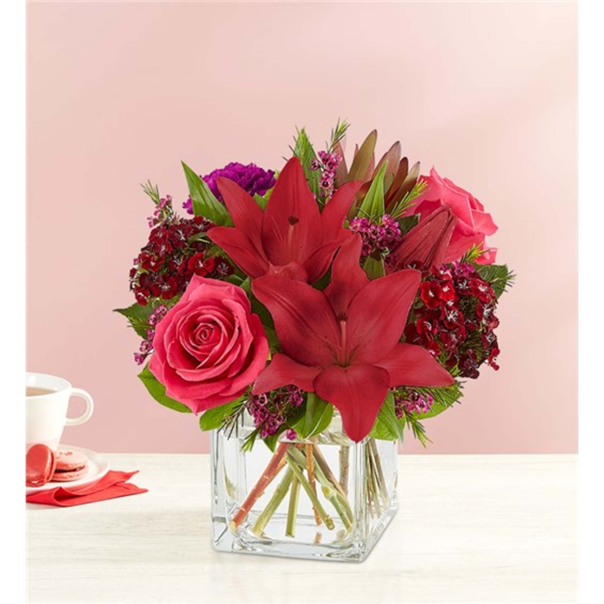 Pink and red floral arrangement in a clear glass vase
