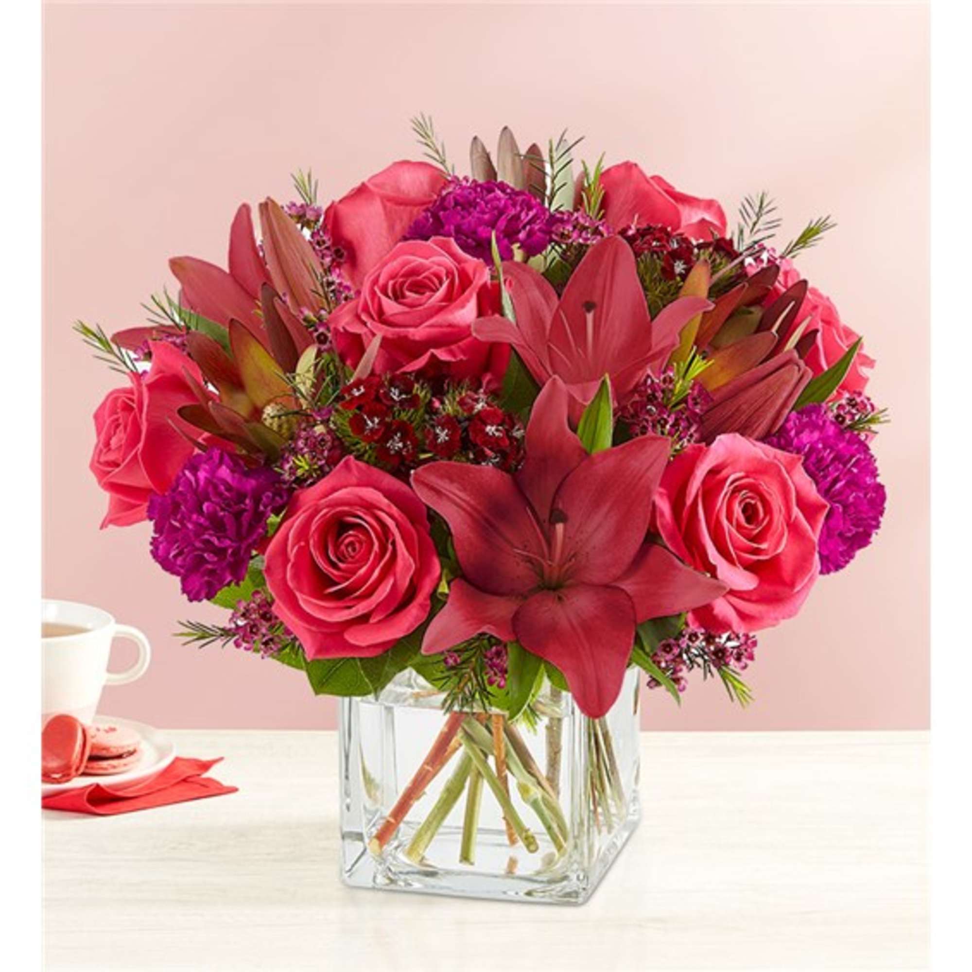 Pink and red flower bouquet in a clear glass vase