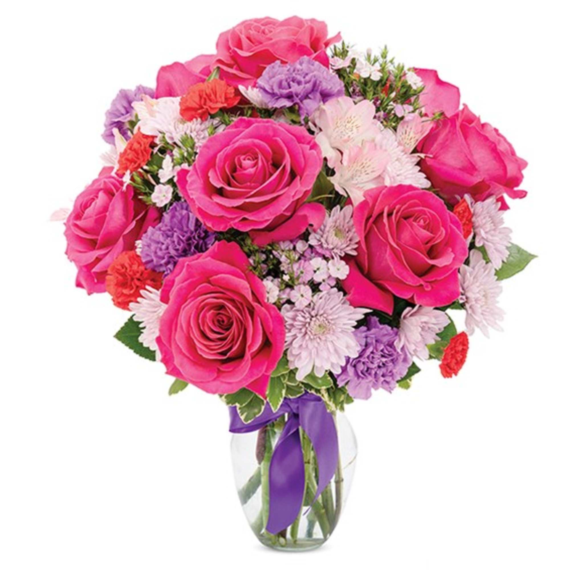 Pink roses and mixed flowers in a clear glass vase with a purple ribbon