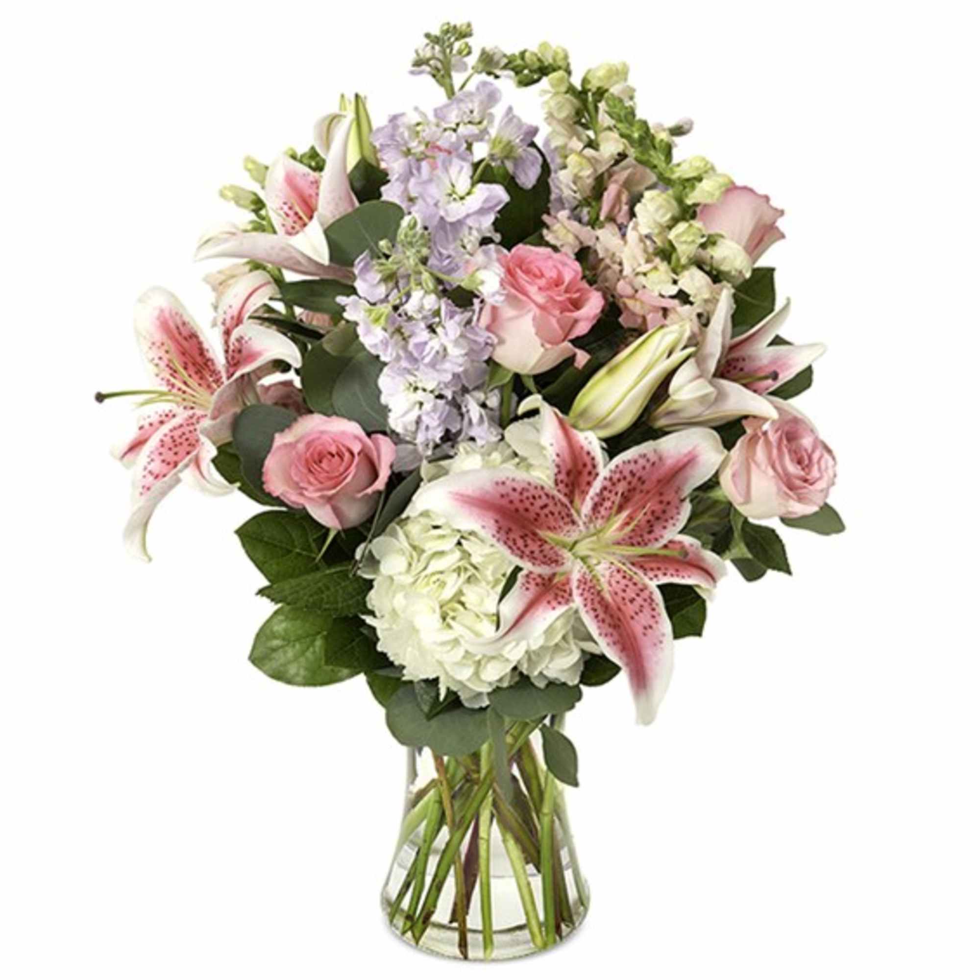 Pink lilies and roses arranged in a clear glass vase