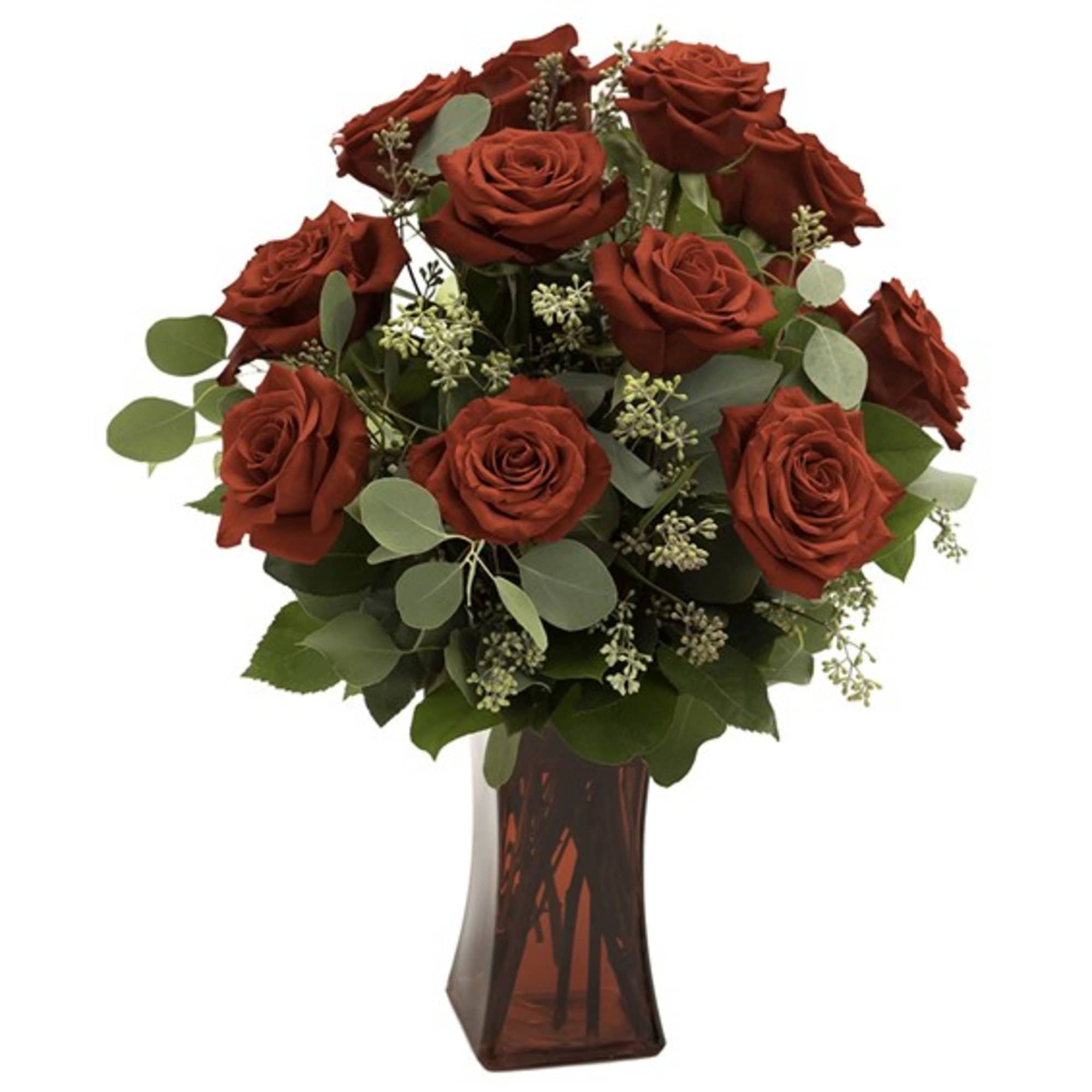 Red roses arranged in a red glass vase with greenery