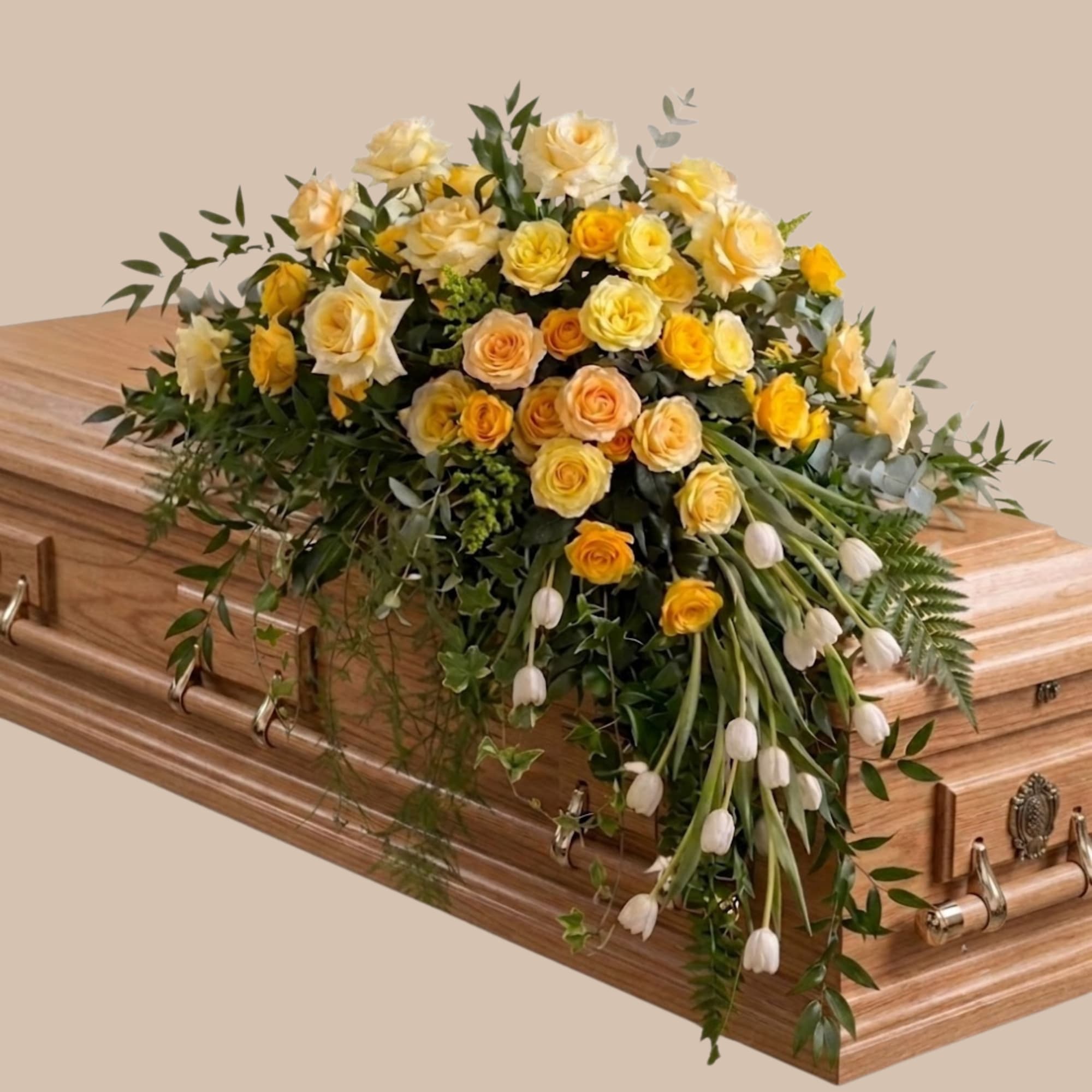 A generous casket spray crafted to convey warmth and gentle comfort, perfect