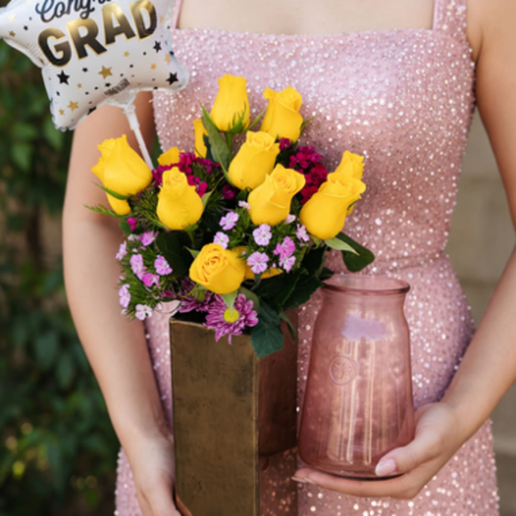 Bright yellow roses take center stage in this cheerful flower arrangement, paired