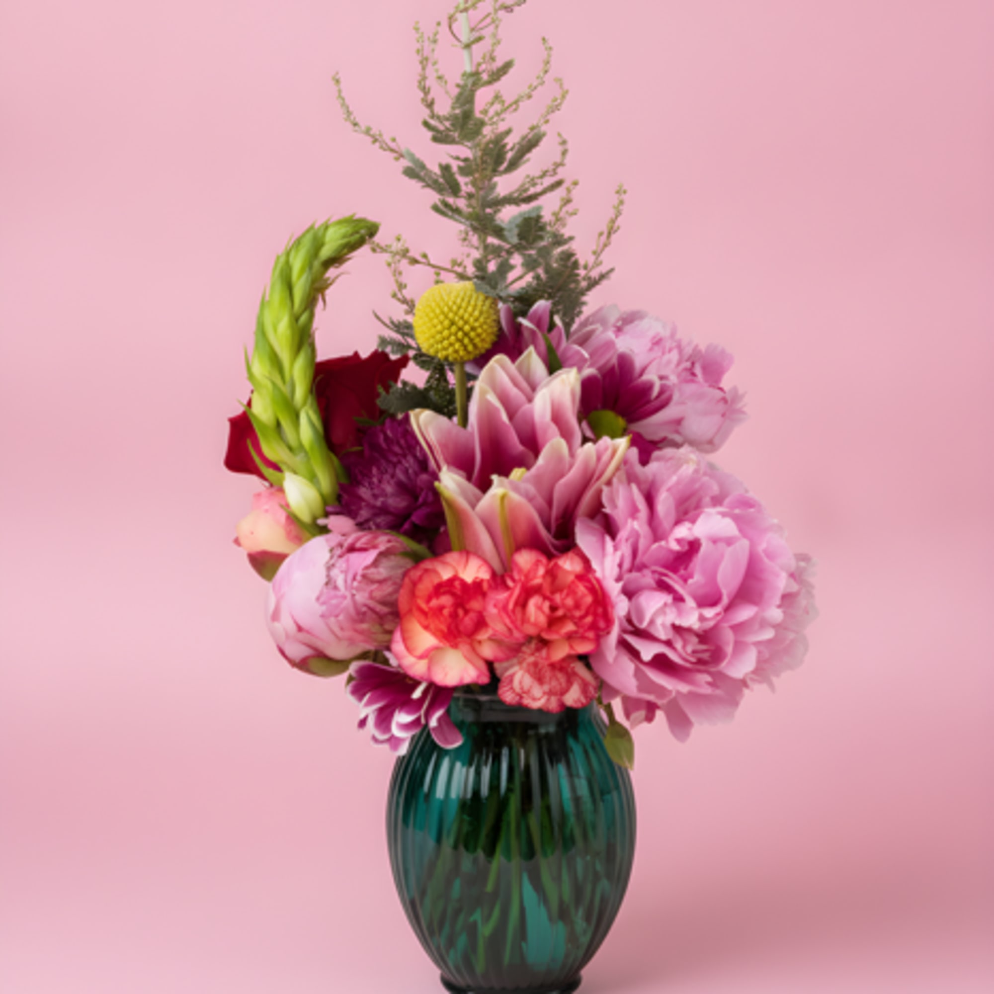 A lively cluster of mixed roses, lilies, carnations, and chrysanthemums in a