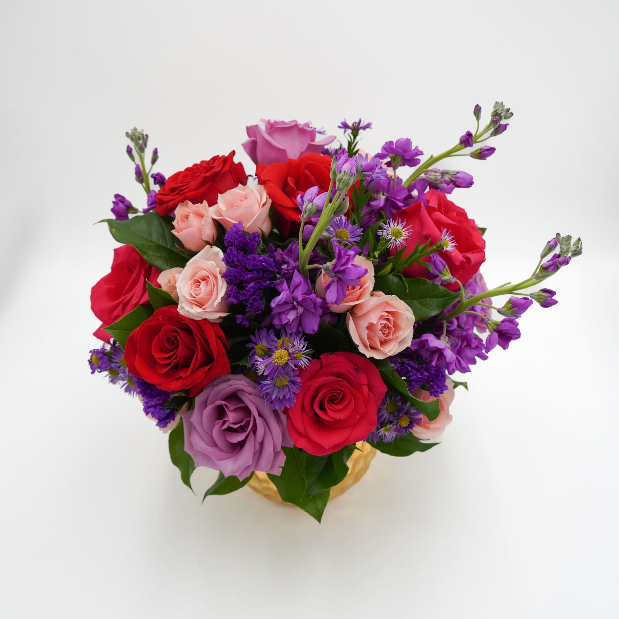 A lush, rounded bouquet of hot pink, red and lavender roses threaded, photo 2 of 2