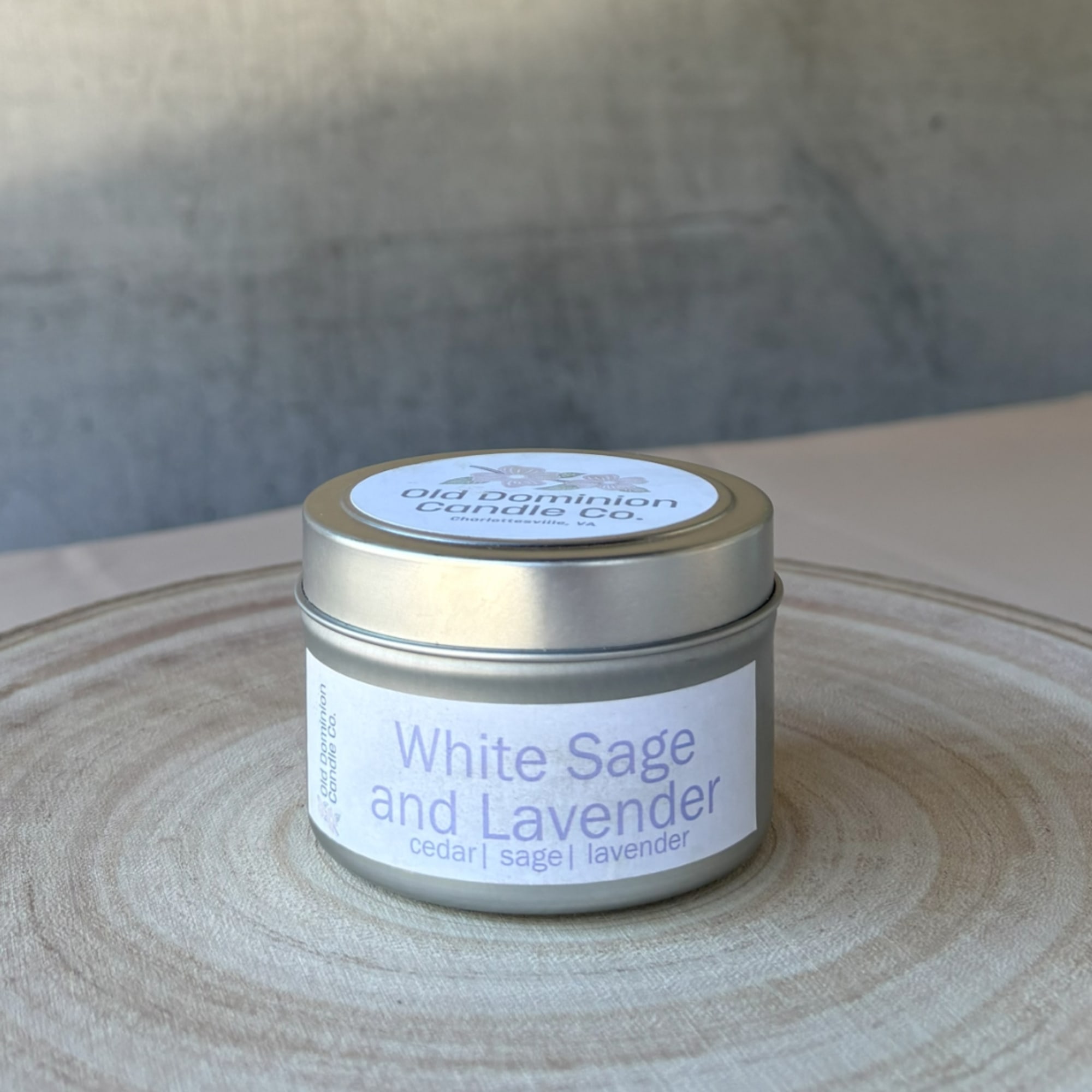 Small tin candle labeled White Sage and Lavender