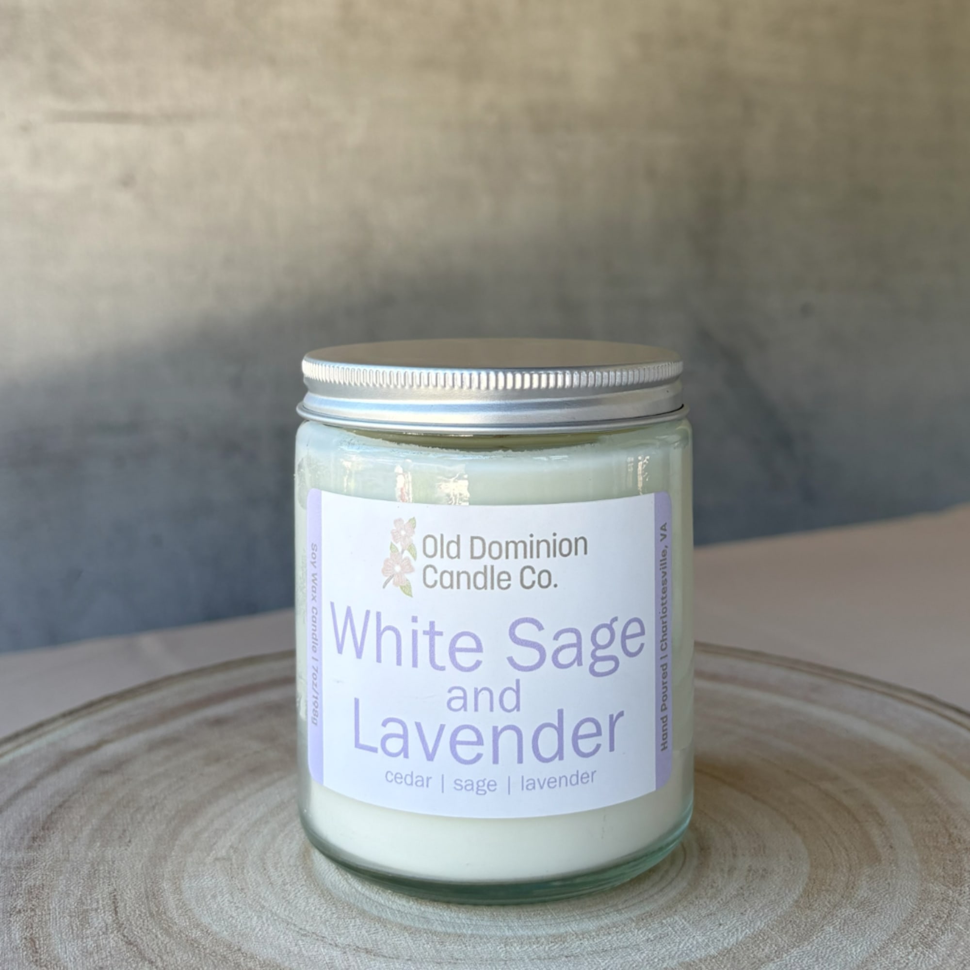 Lavender-scented candle in a glass jar with a silver lid