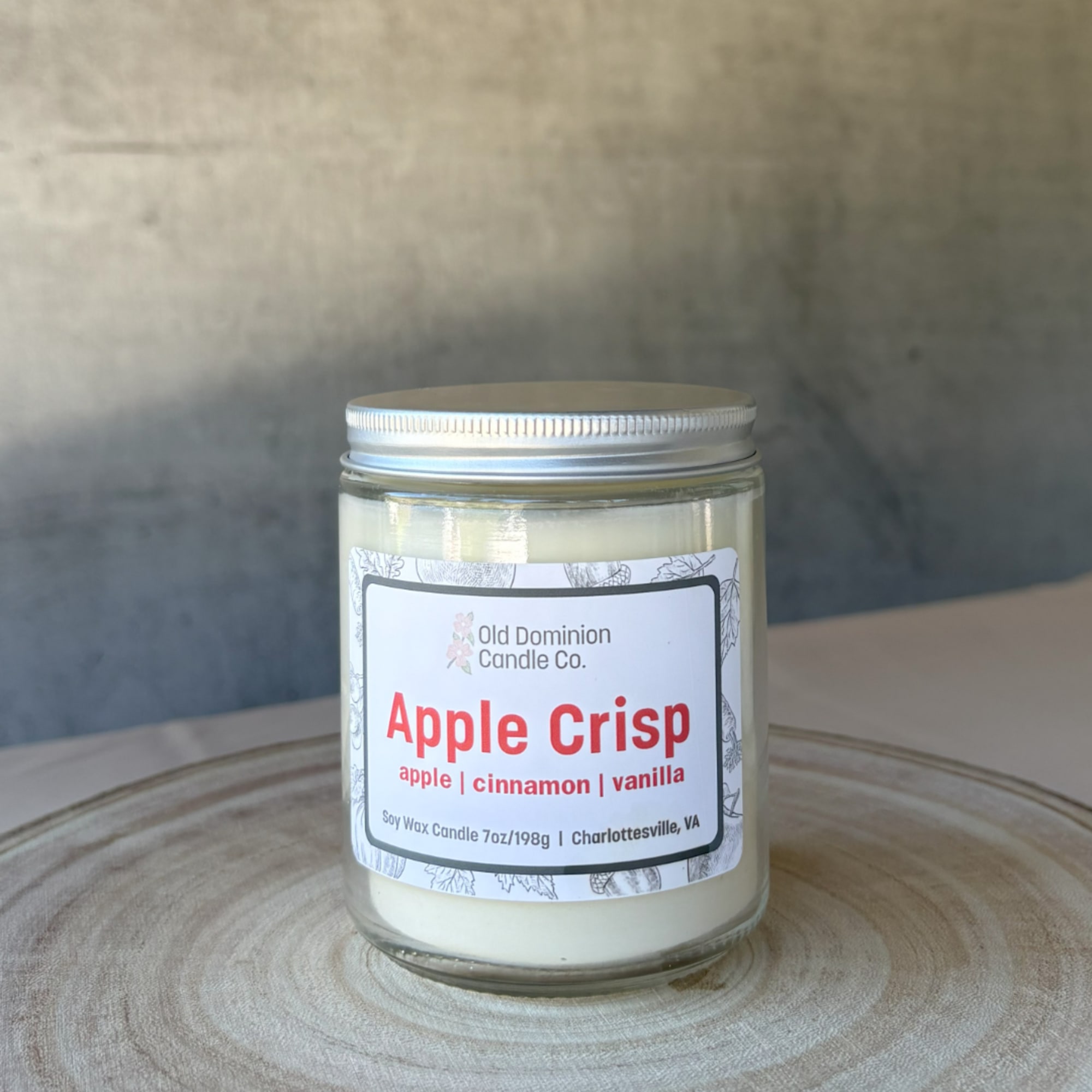 Apple Crisp candle in a glass jar with a silver lid