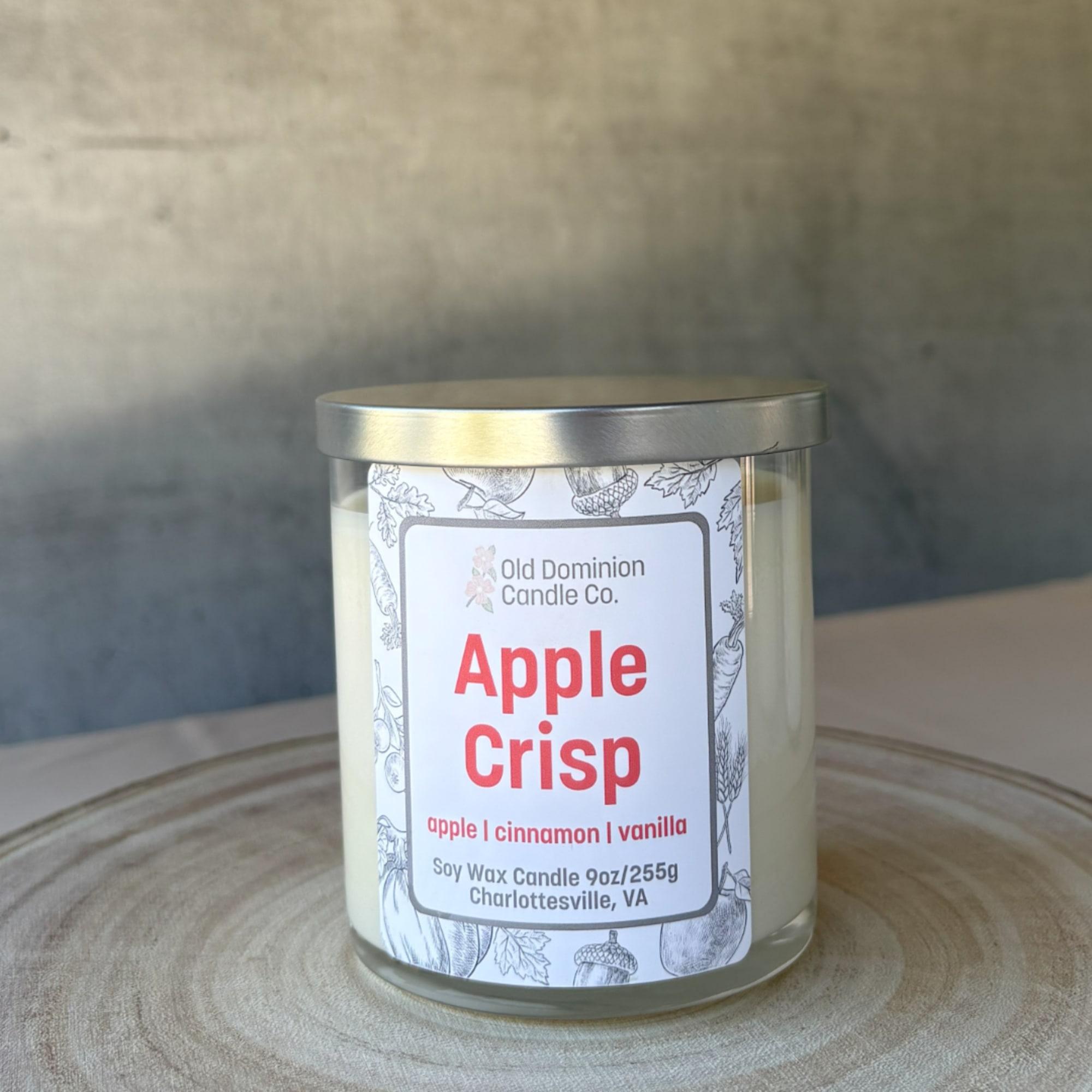 Apple Crisp soy candle in a glass jar with a metal lid