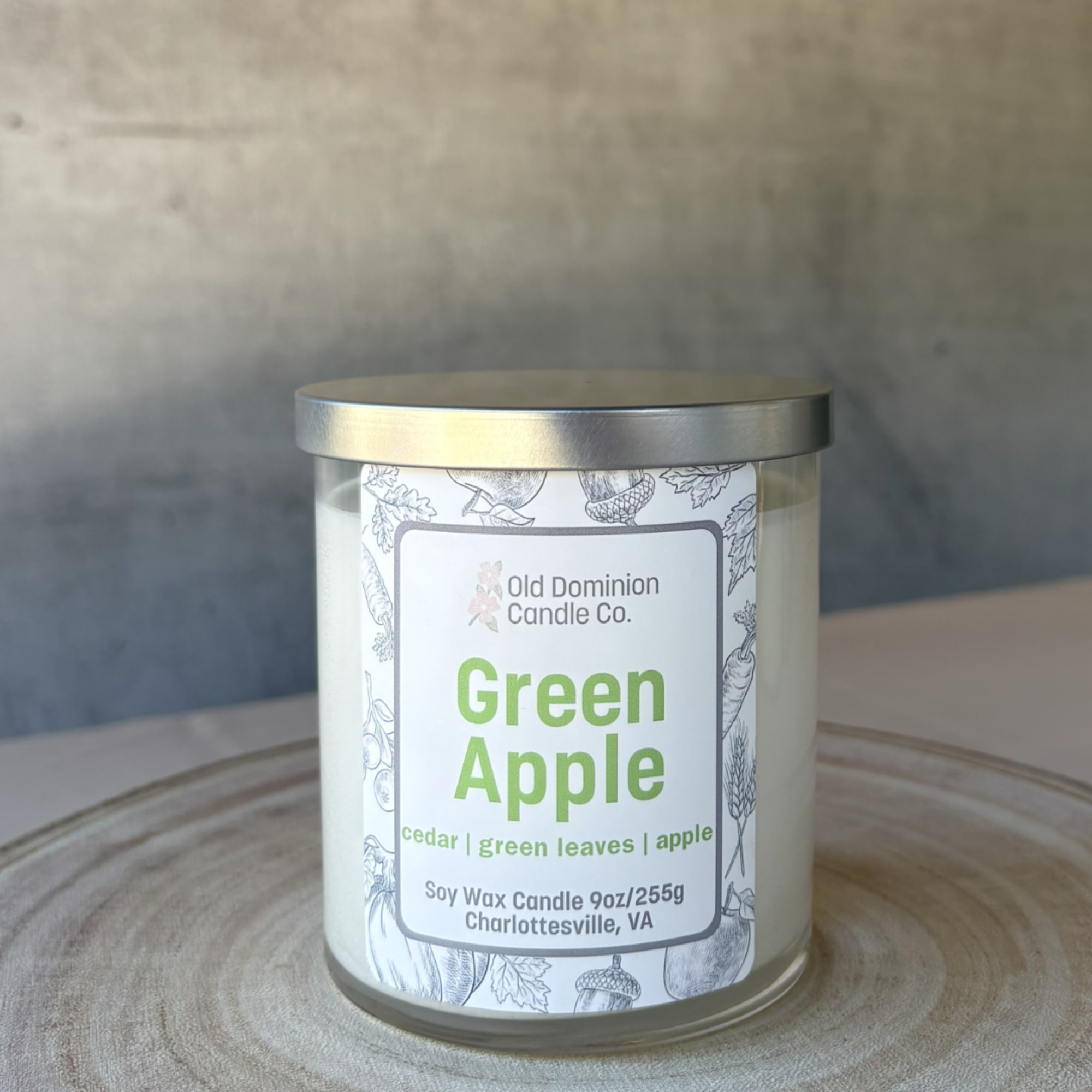 Green Apple soy candle in a glass jar with a metal lid