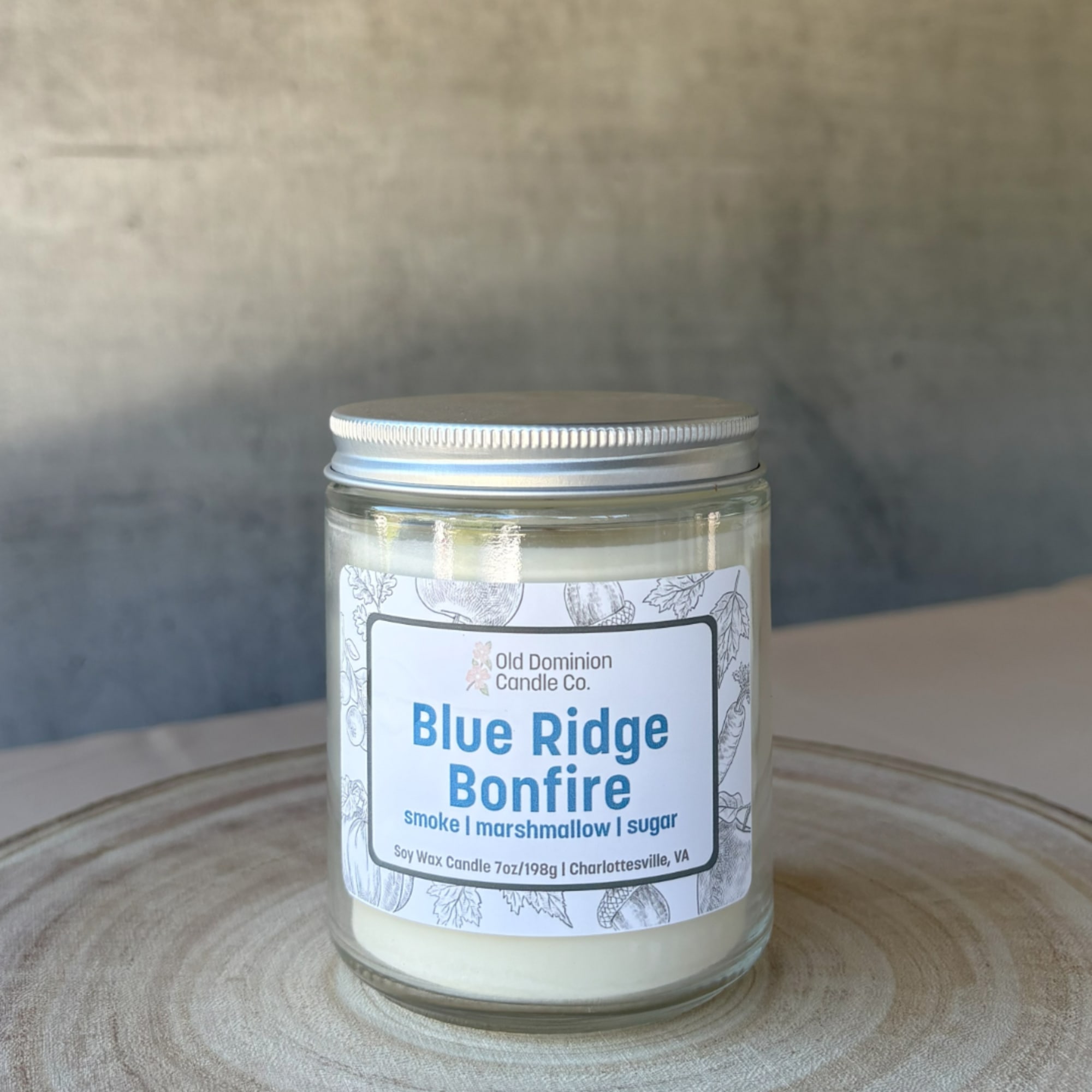 Jar candle labeled Blue Ridge Bonfire on a table