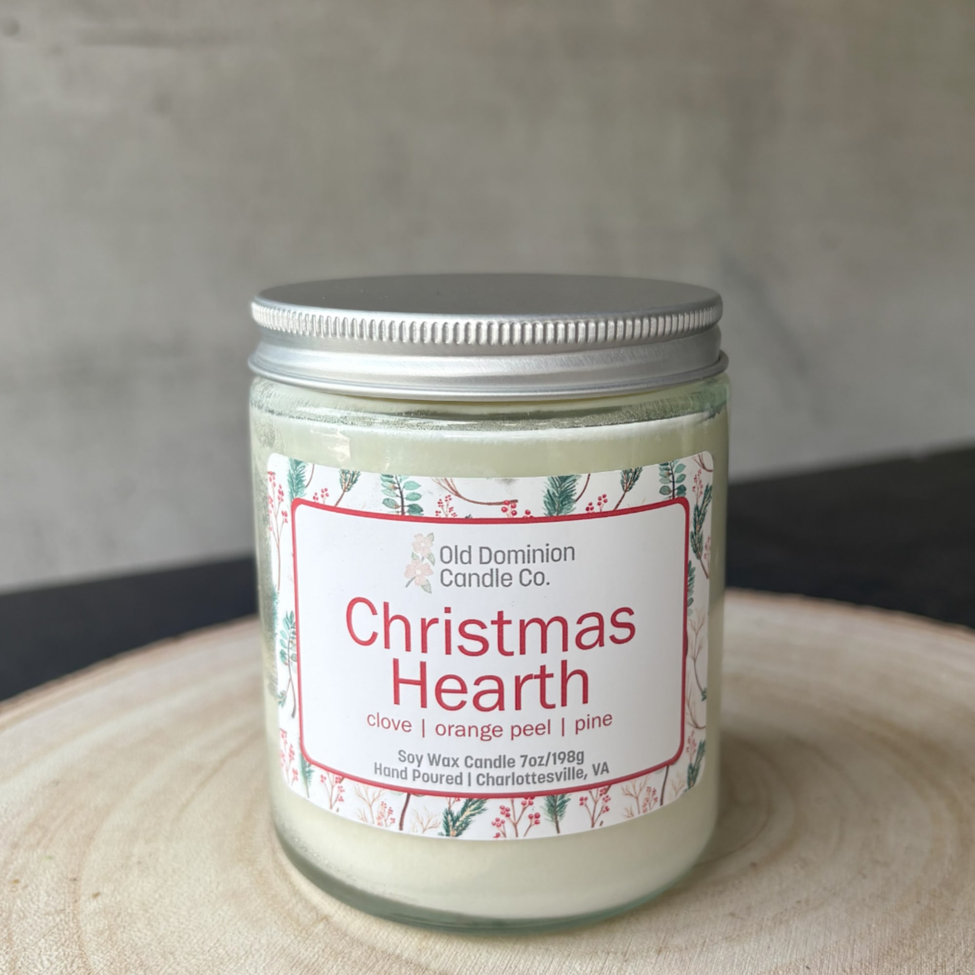 Christmas Hearth soy candle in a glass jar with a silver lid