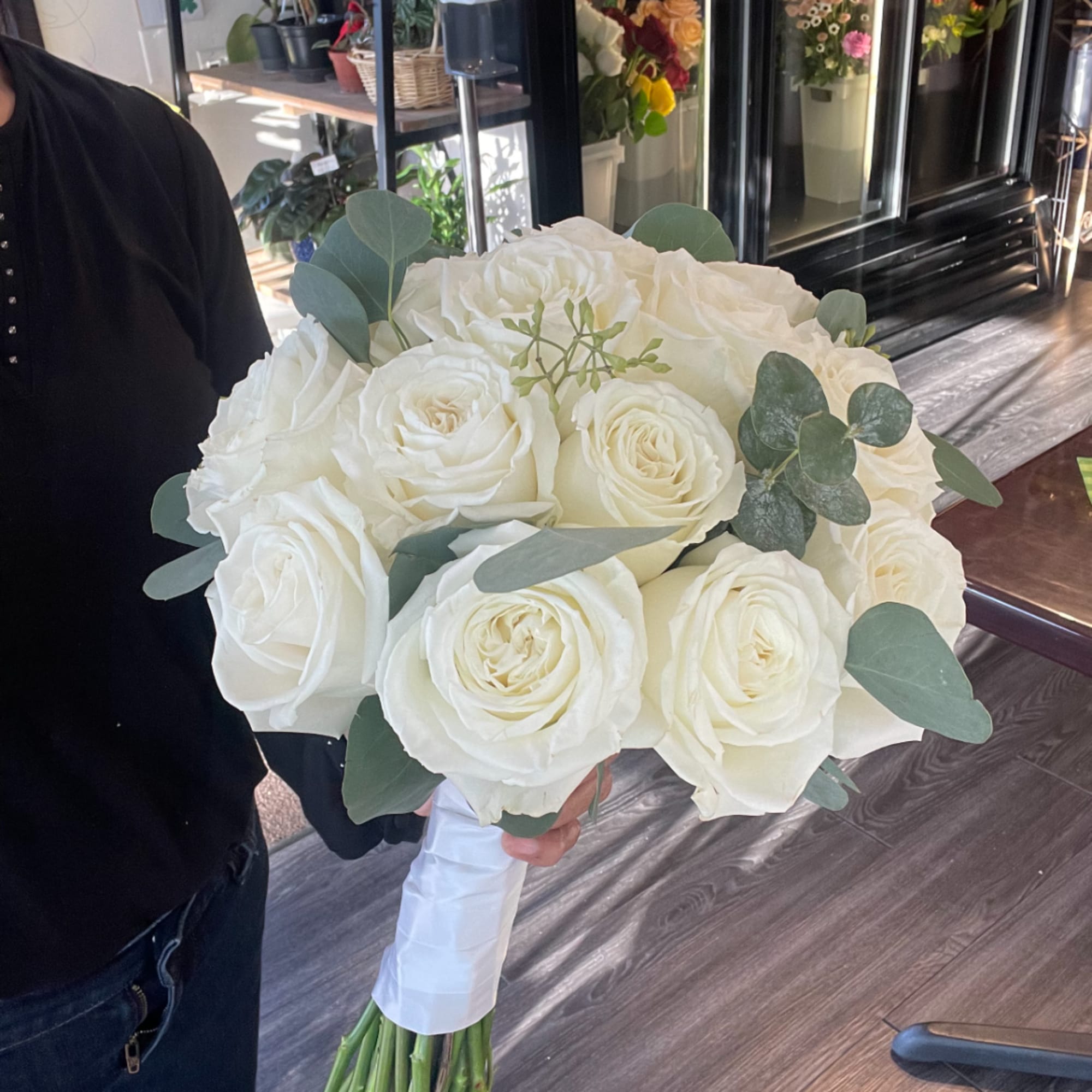 White rose bridal bouquet with eucalyptus greenery, photo 3 of 3