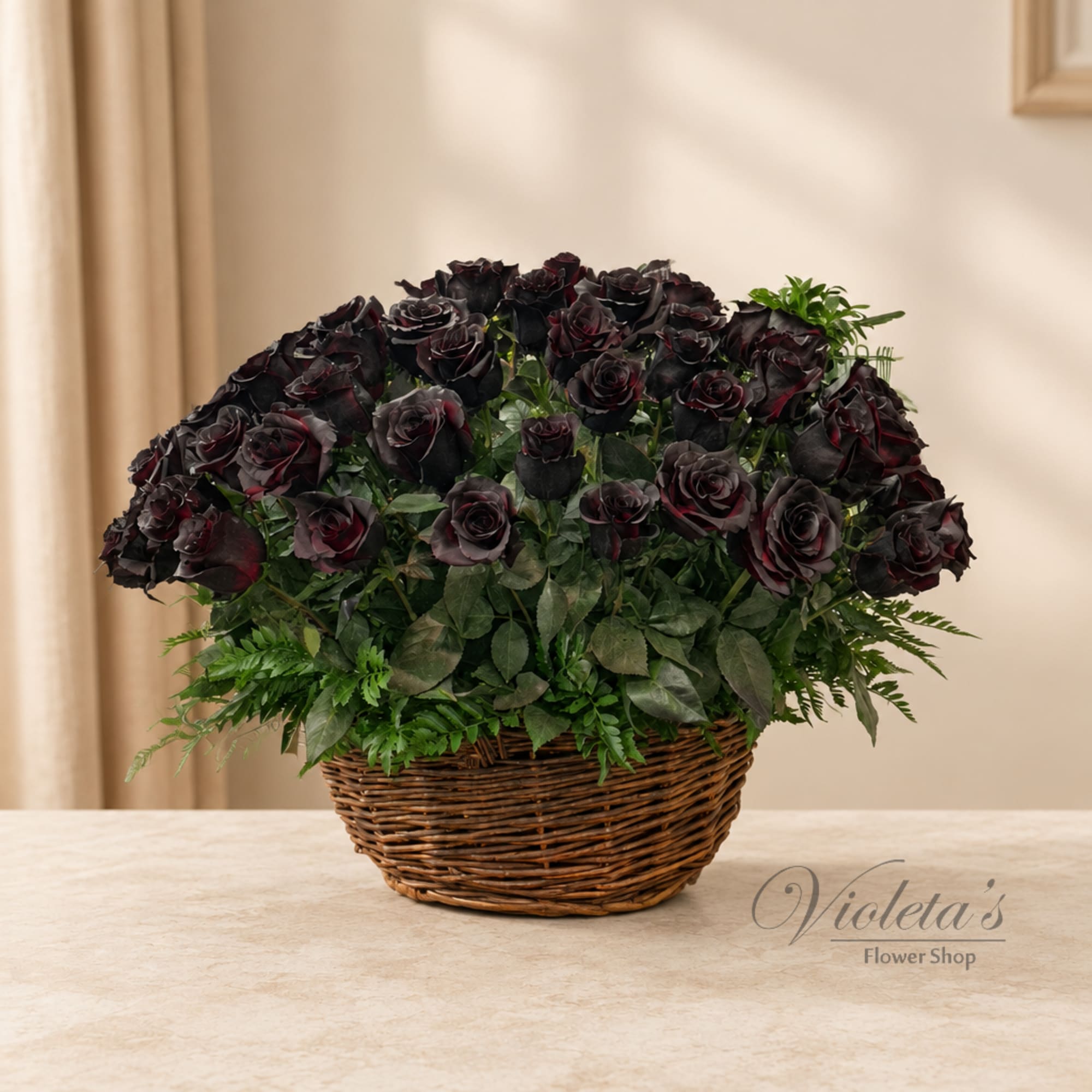 Basket arrangement of dark roses with greenery