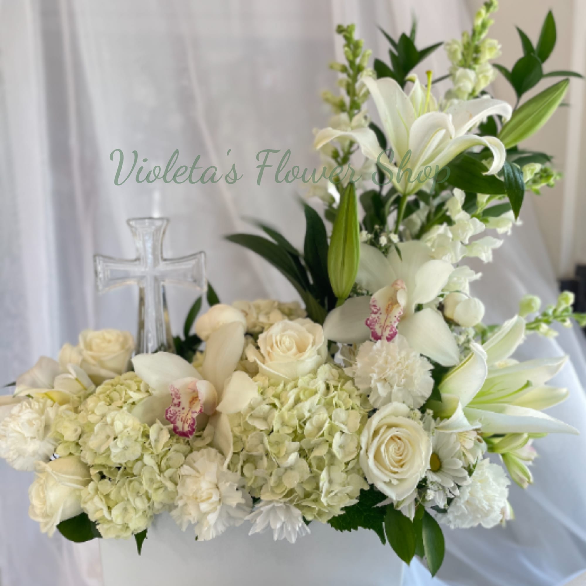 A serene, upright sympathy arrangement centered on pure white lilies and a, photo 2 of 2