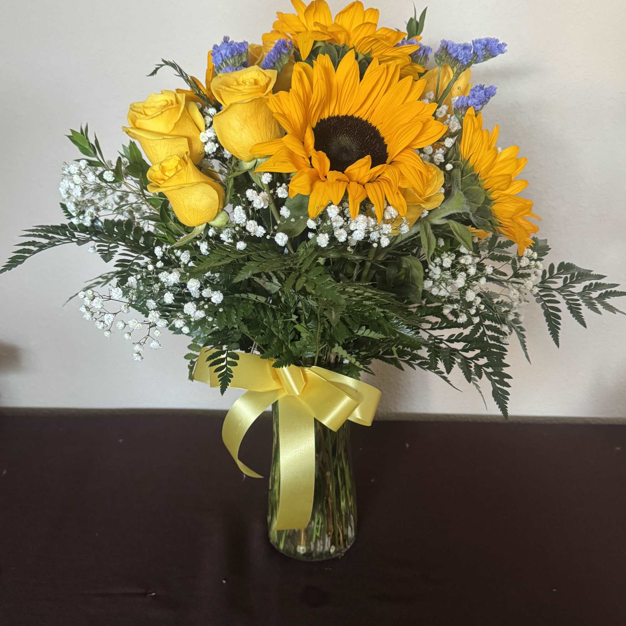 A beautiful vase with yellow roses and sunflowers. Perfect for national yellow