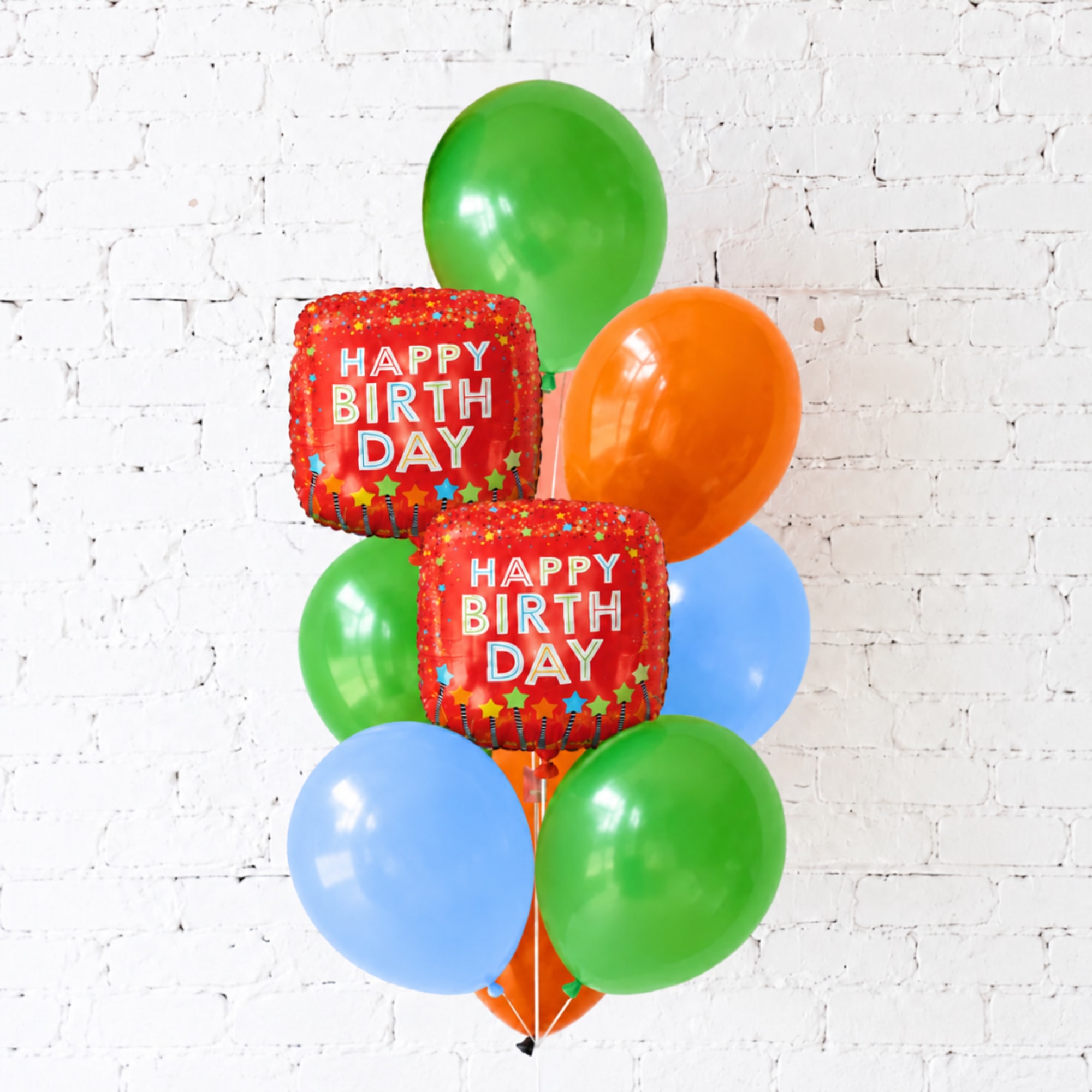 Birthday balloon bouquet with colorful round balloons and two red "Happy Birthday" balloons
