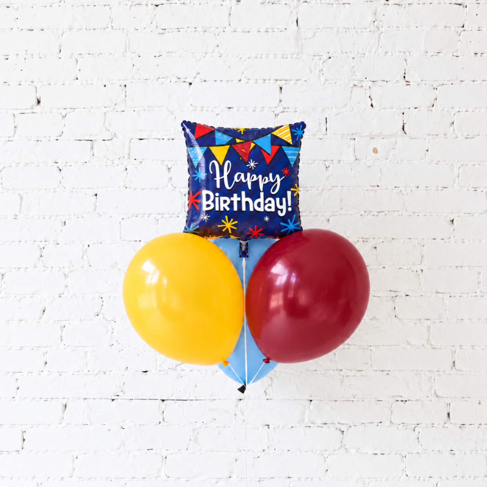 Birthday balloon bouquet with a square foil balloon and two latex balloons