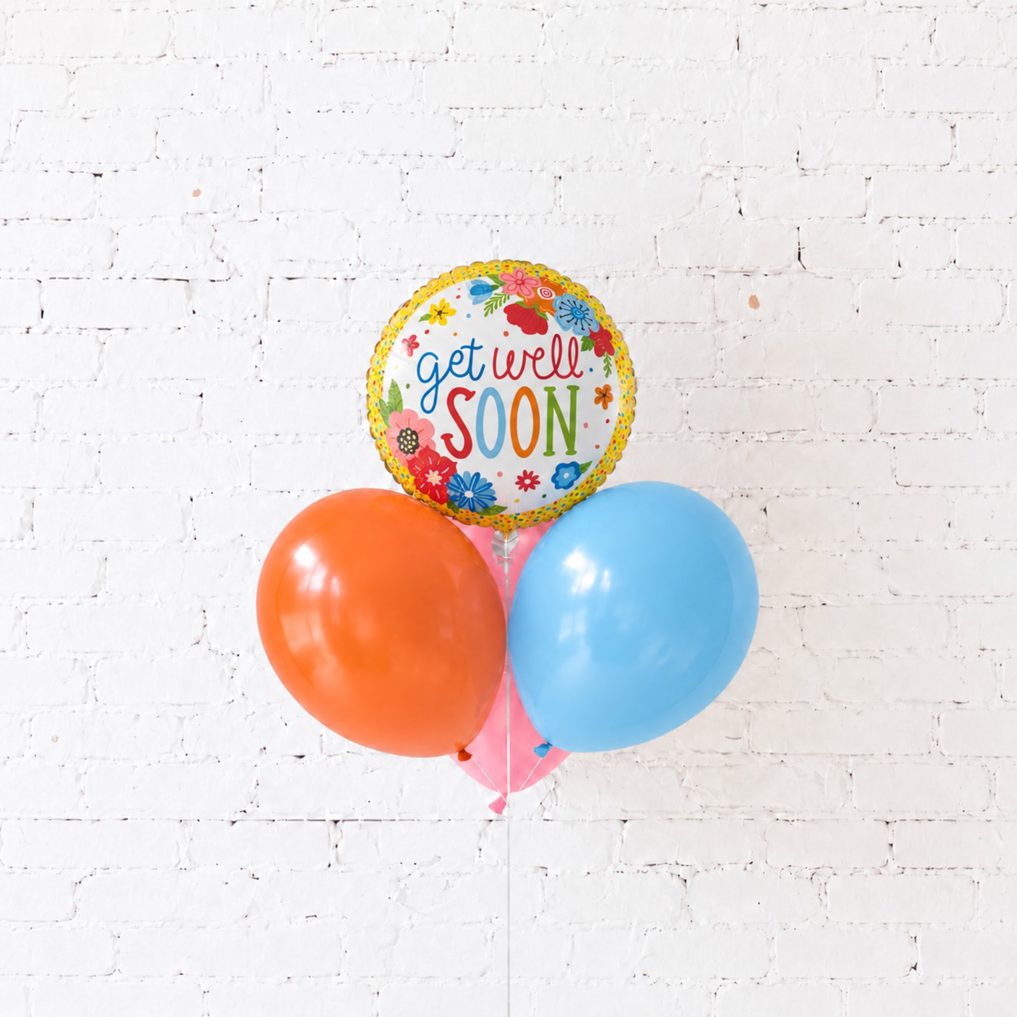 Get well soon balloon bouquet with orange, blue, and pink balloons