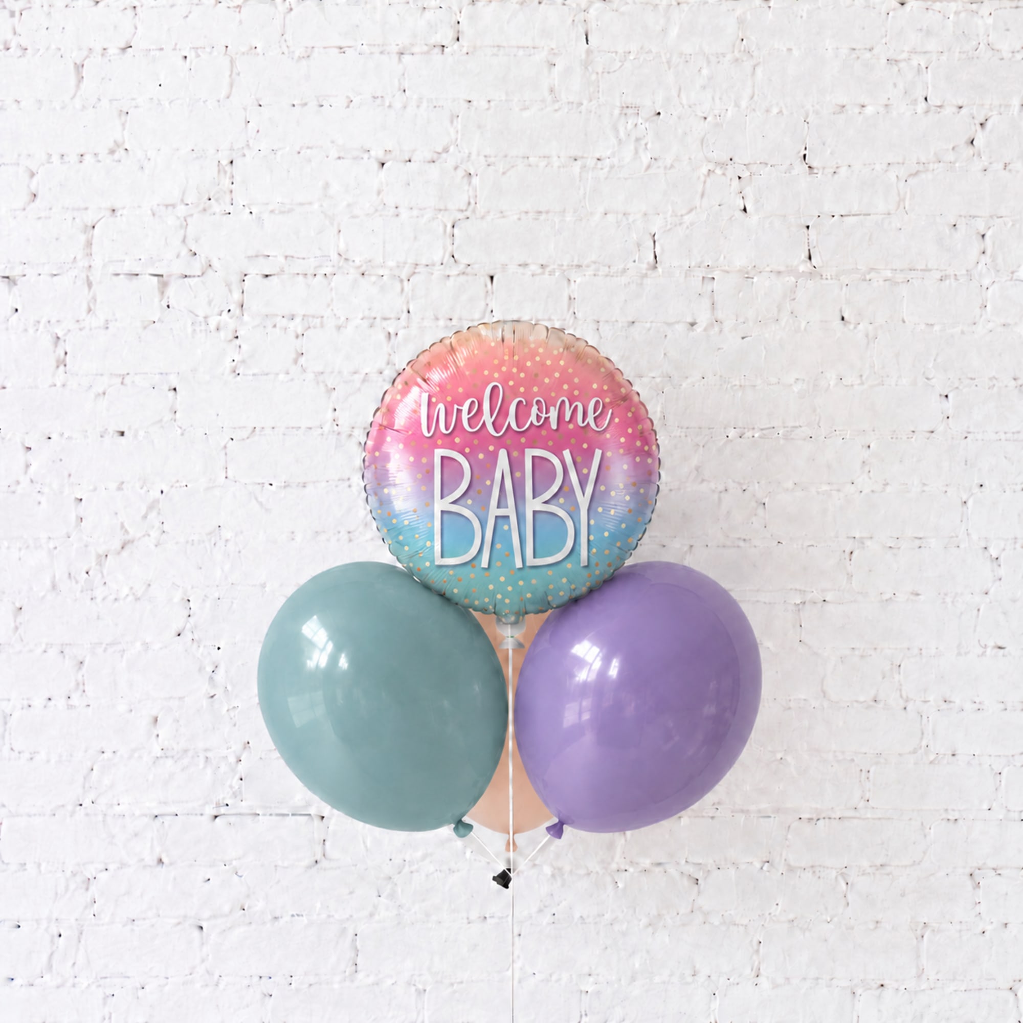 Pastel baby shower balloon cluster with a welcome baby foil balloon