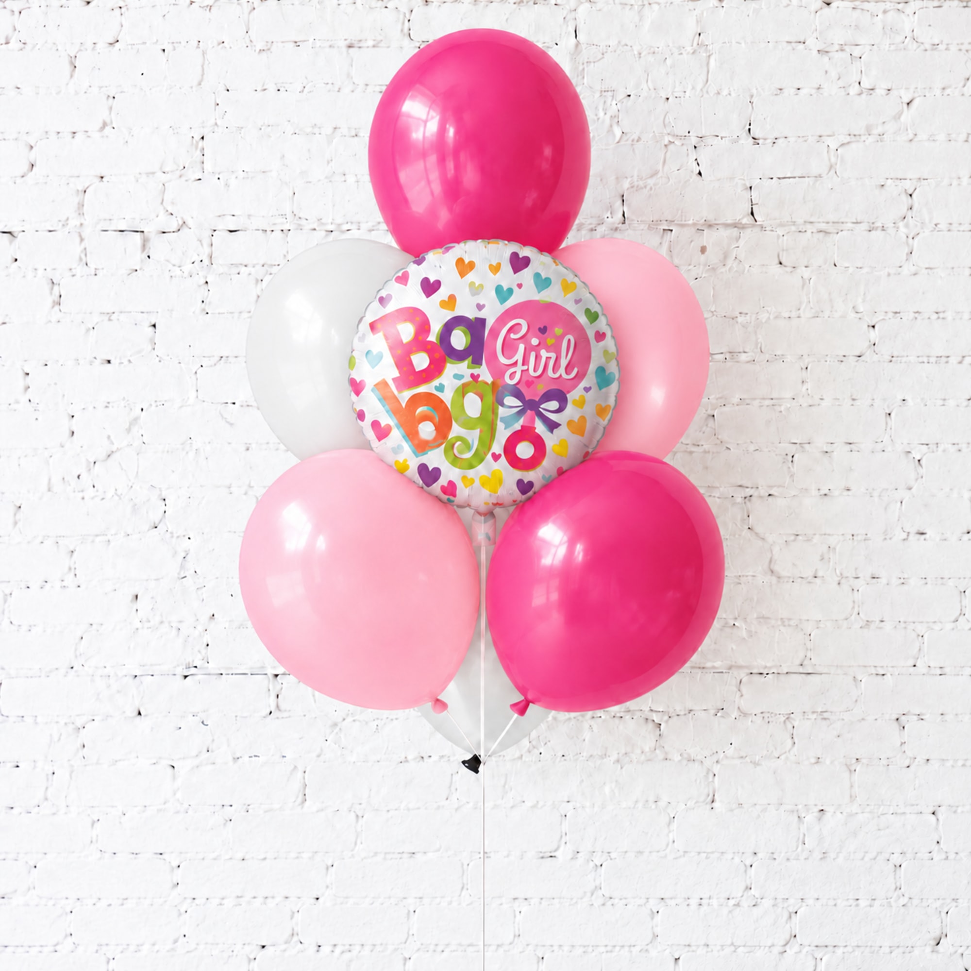 Pink and white balloons with a "Baby Girl" foil balloon