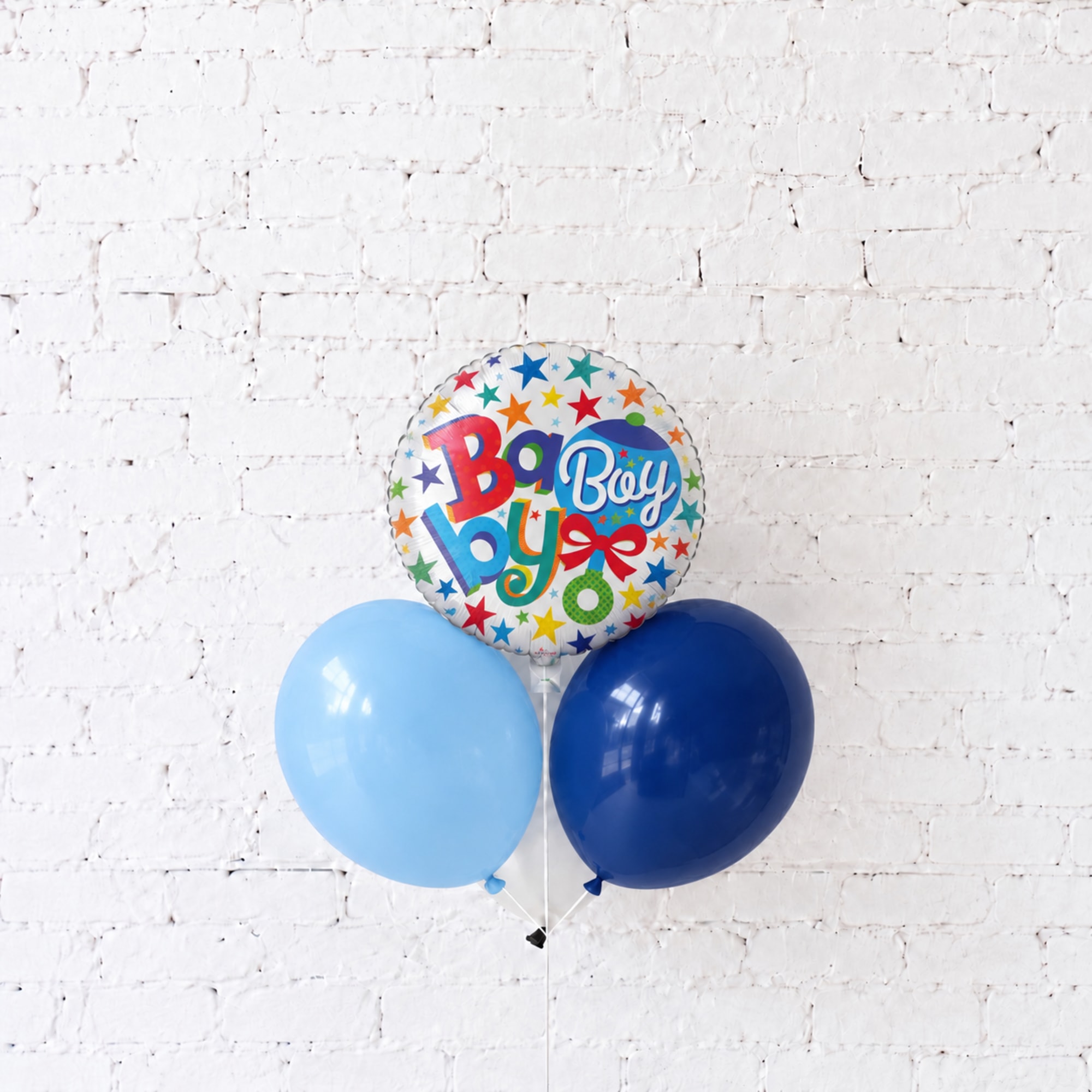 Boy-themed balloon bouquet with two blue balloons and a starry foil balloon