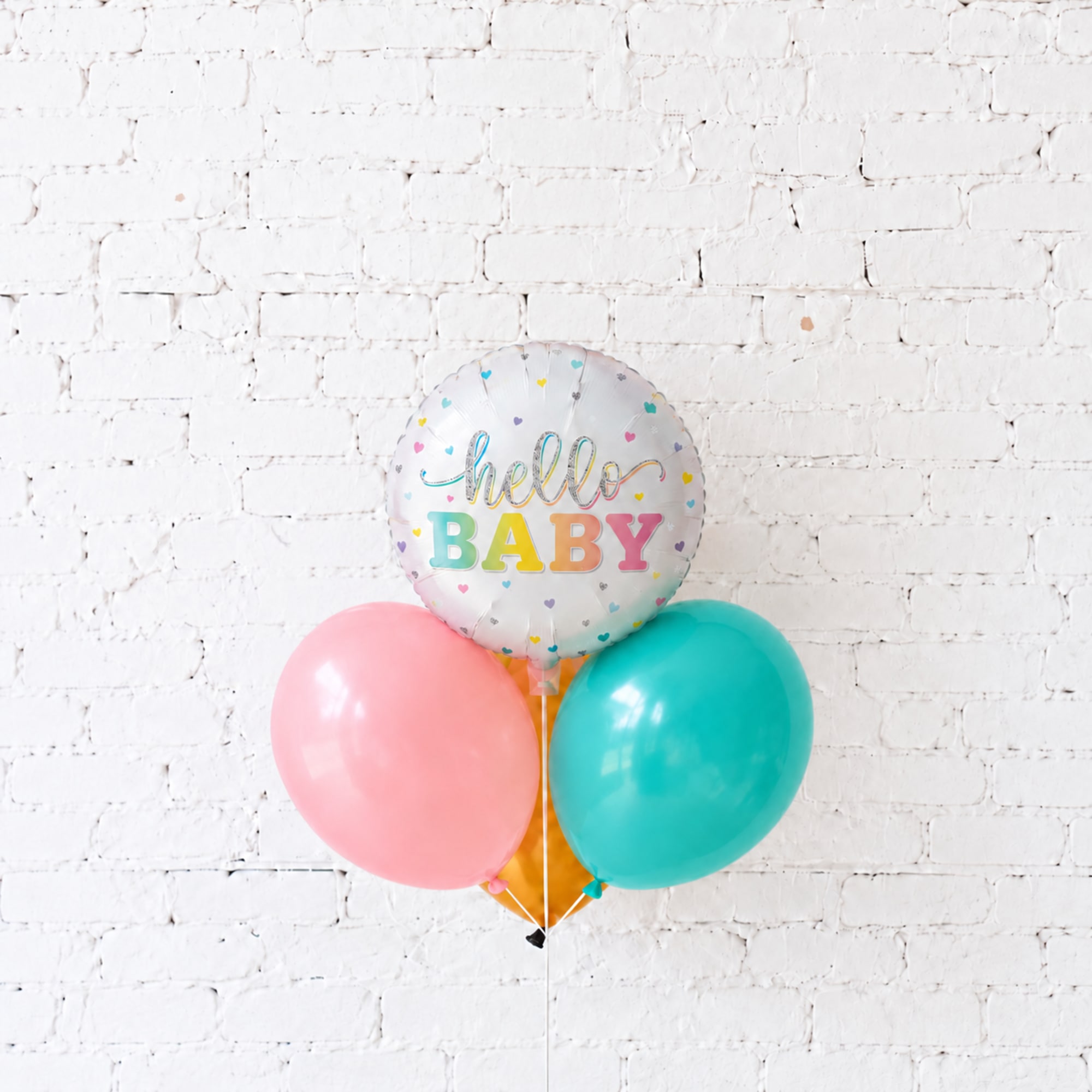 Baby-themed balloon cluster with a "hello BABY" foil balloon