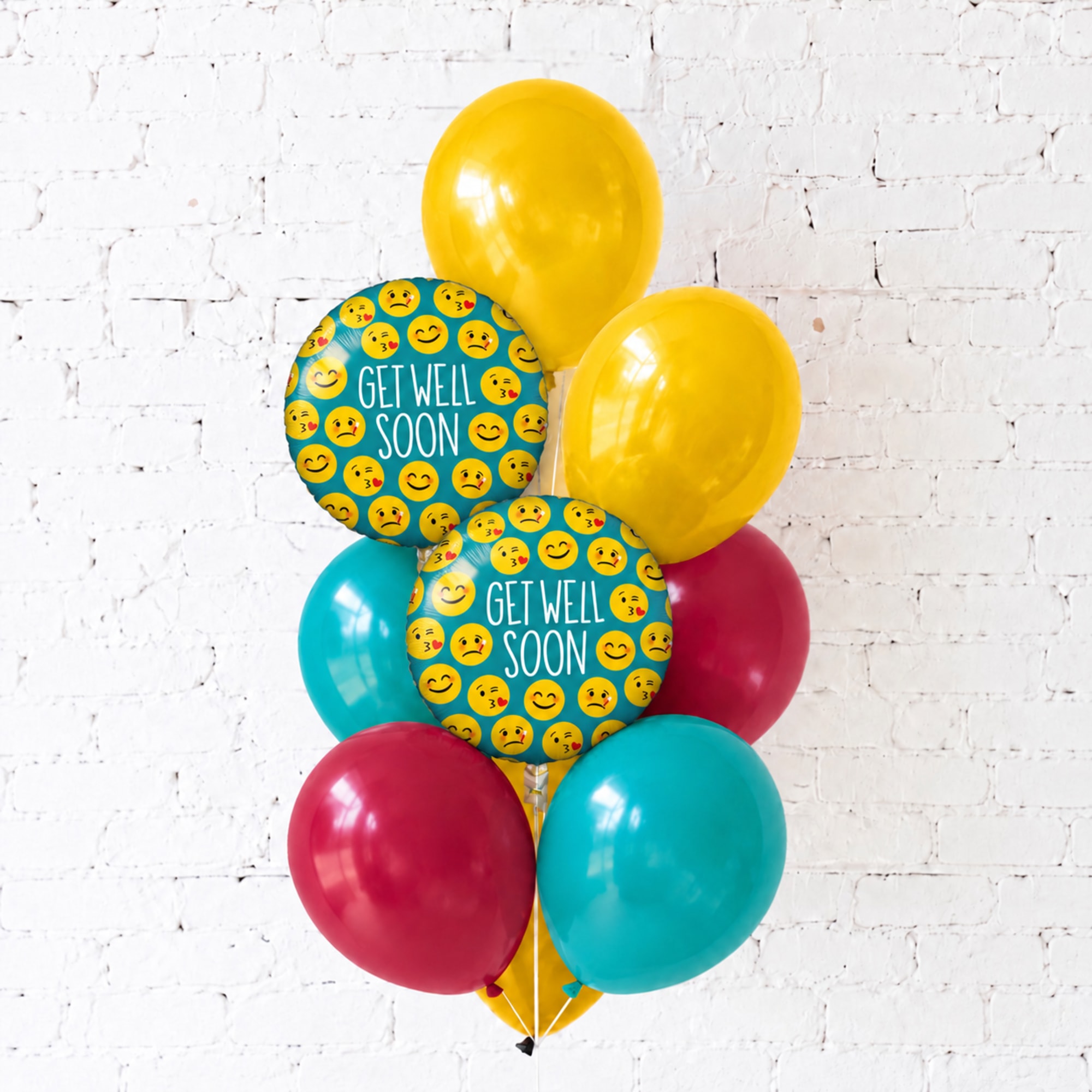 Get well soon balloon bouquet with yellow, teal, and pink balloons
