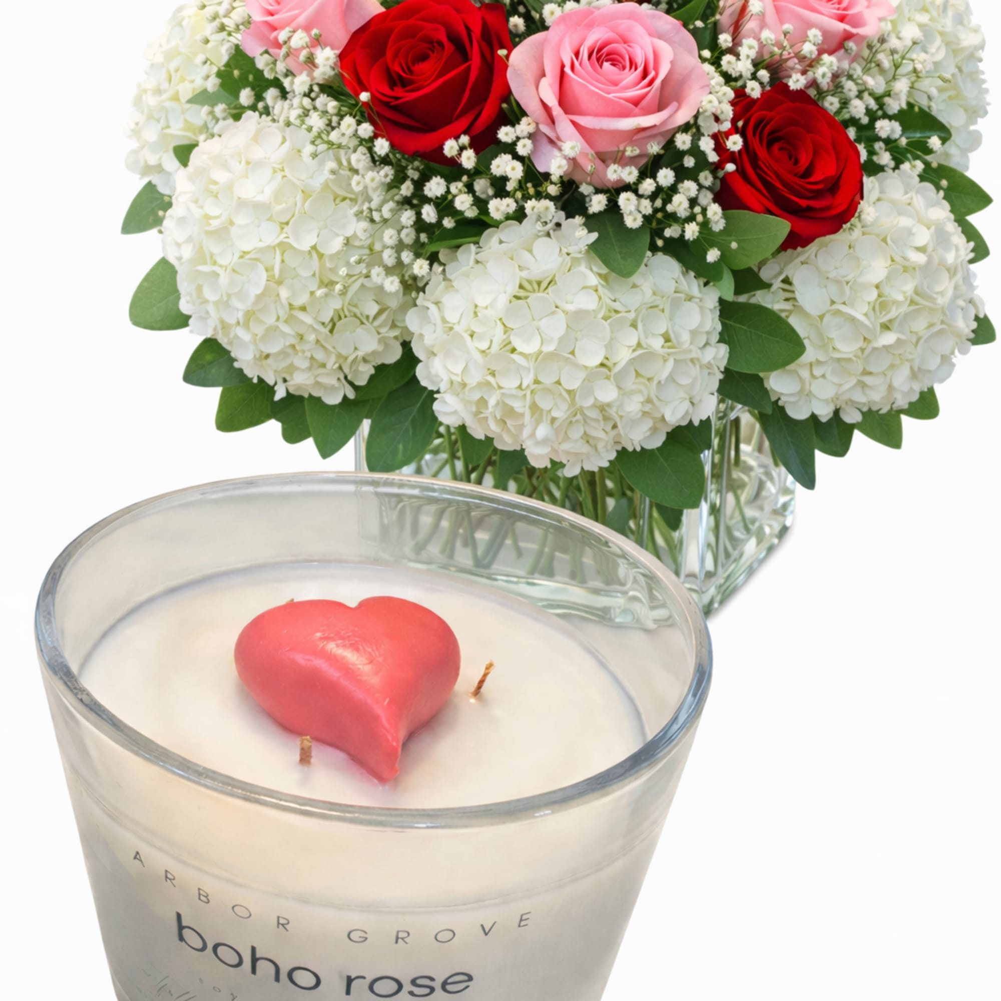 Bouquet of red and pink roses with white hydrangeas and a heart candle