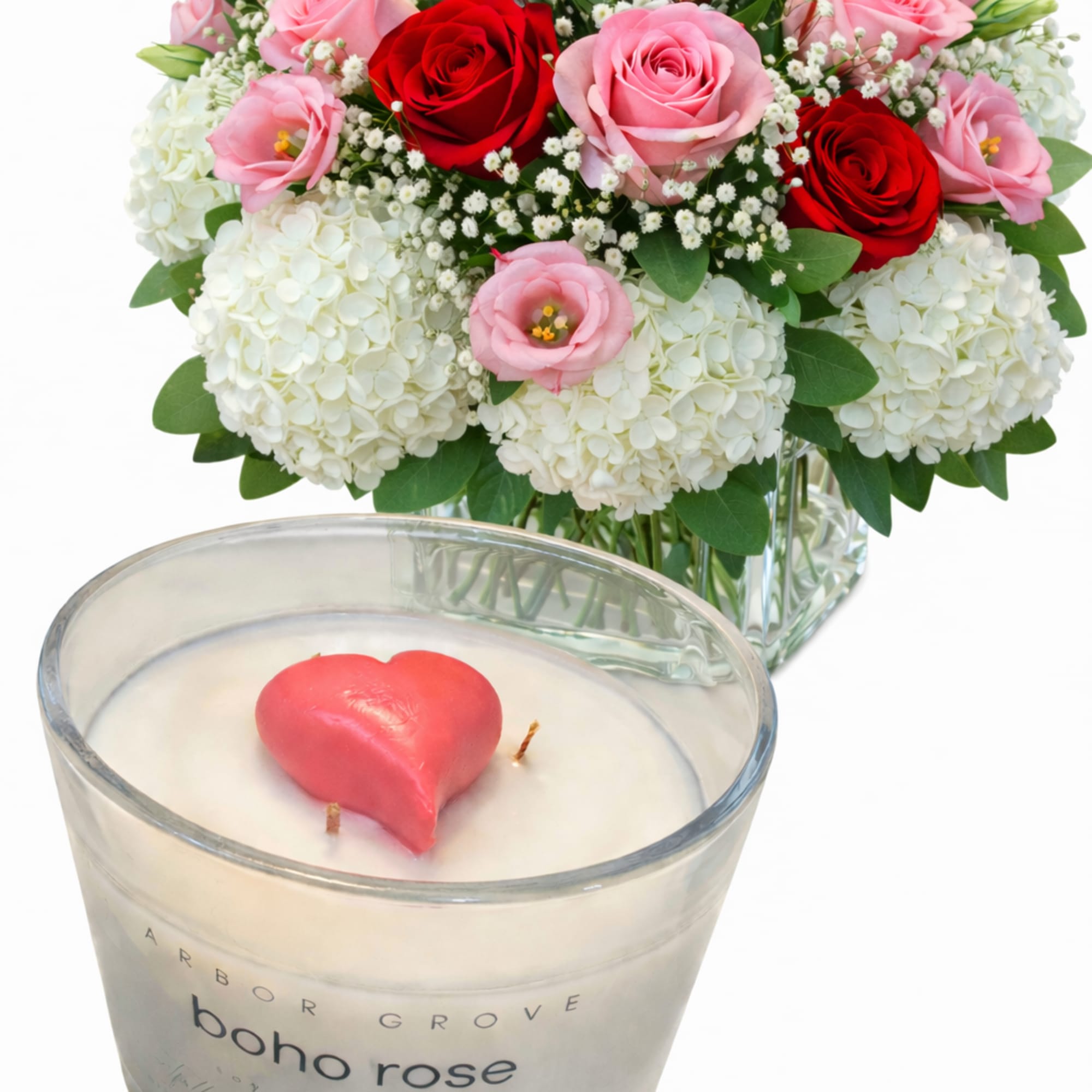 Bouquet of pink and red roses with white hydrangeas and a heart candle