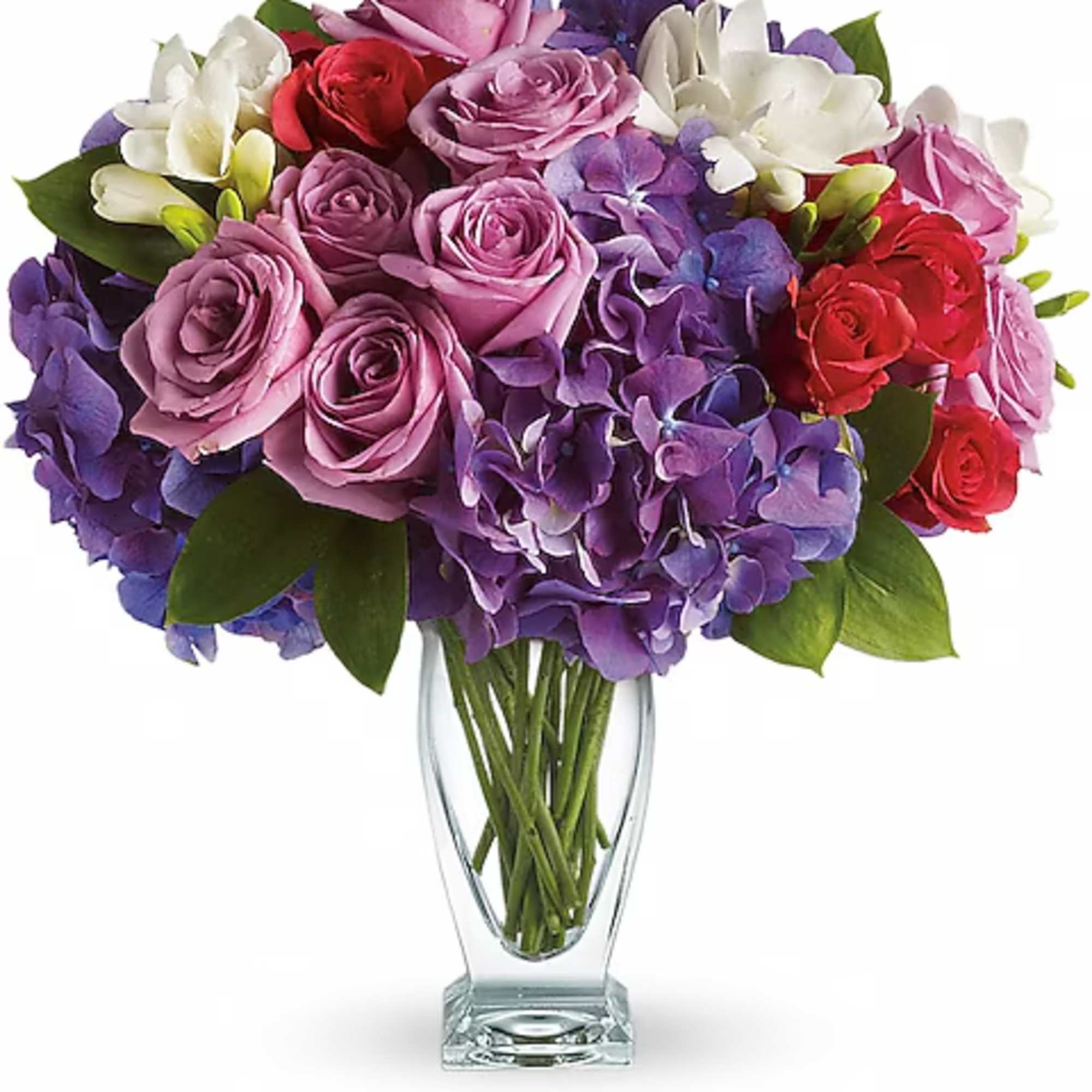 Bouquet of pink, purple, red, and white flowers in a clear glass vase