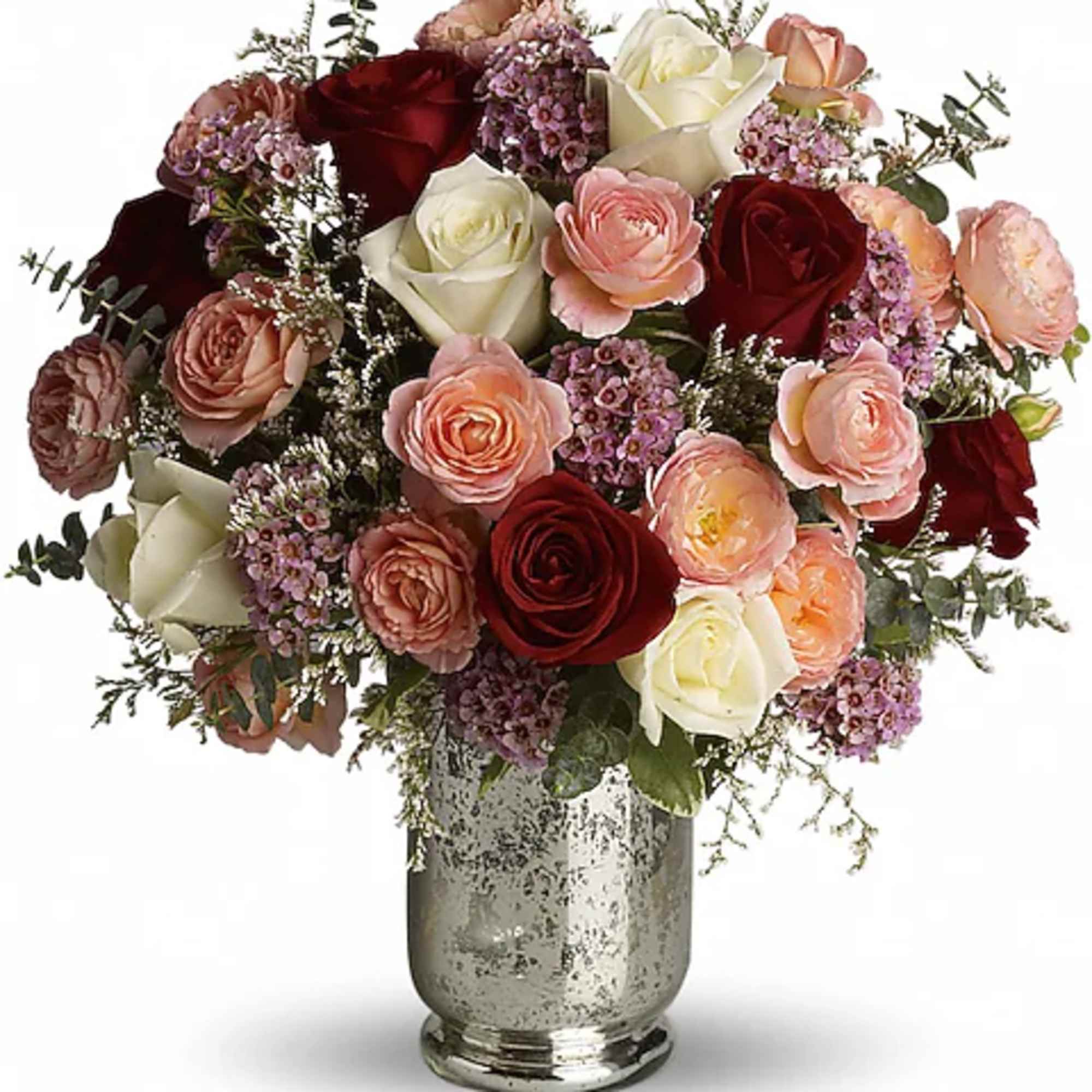 Mixed roses in pink, cream, and red arranged in a silver vase