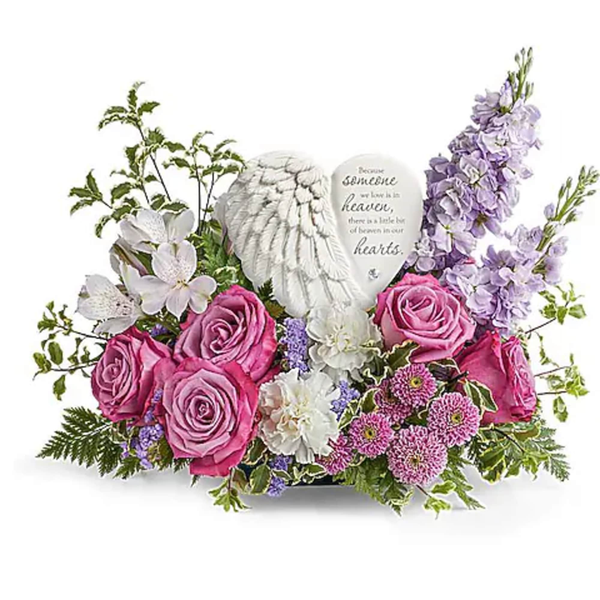 Pink and white floral arrangement with a heart memorial plaque